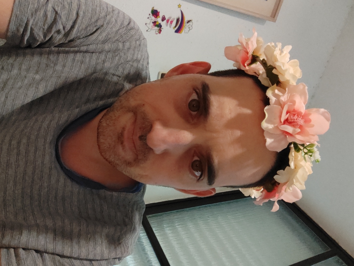 Man poses in flower crown for photo in Tel Aviv