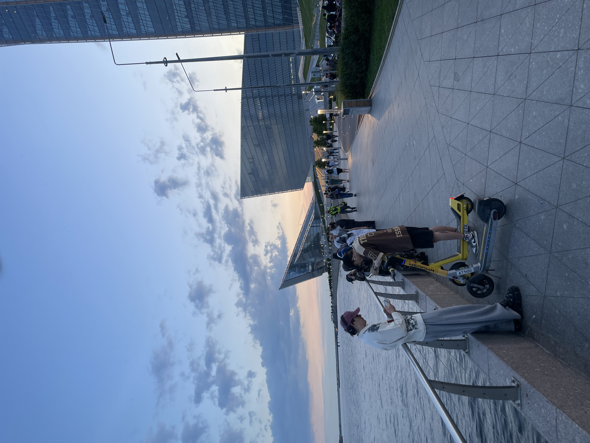 Evening gatherings documented along urban waterfront promenade during golden hour
