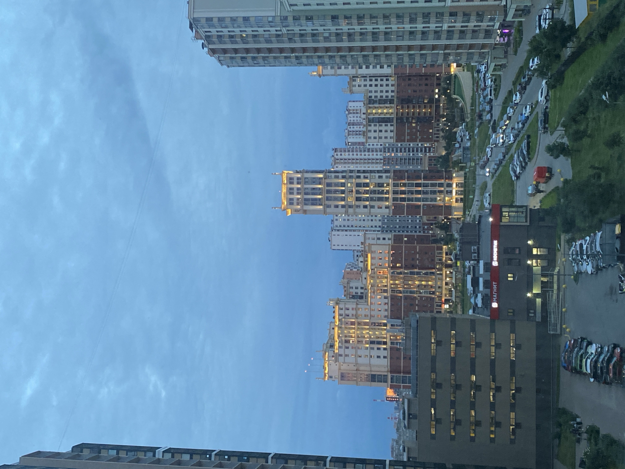 Residential skyline at dusk, high-rises under a deep blue sky
