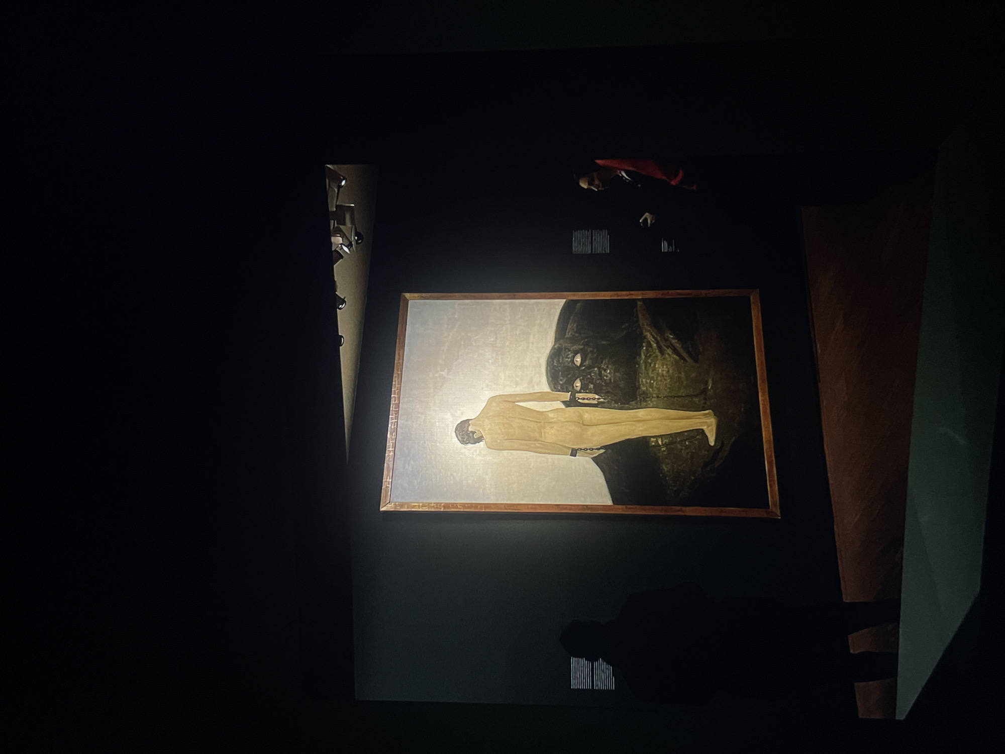 Museum visitor documents collection of artworks featuring restrained figures