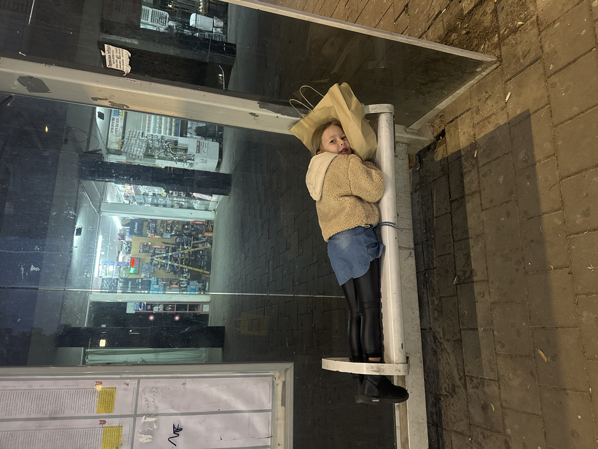 Girl with paper bag over head spotted at Bat Yam bus stop
