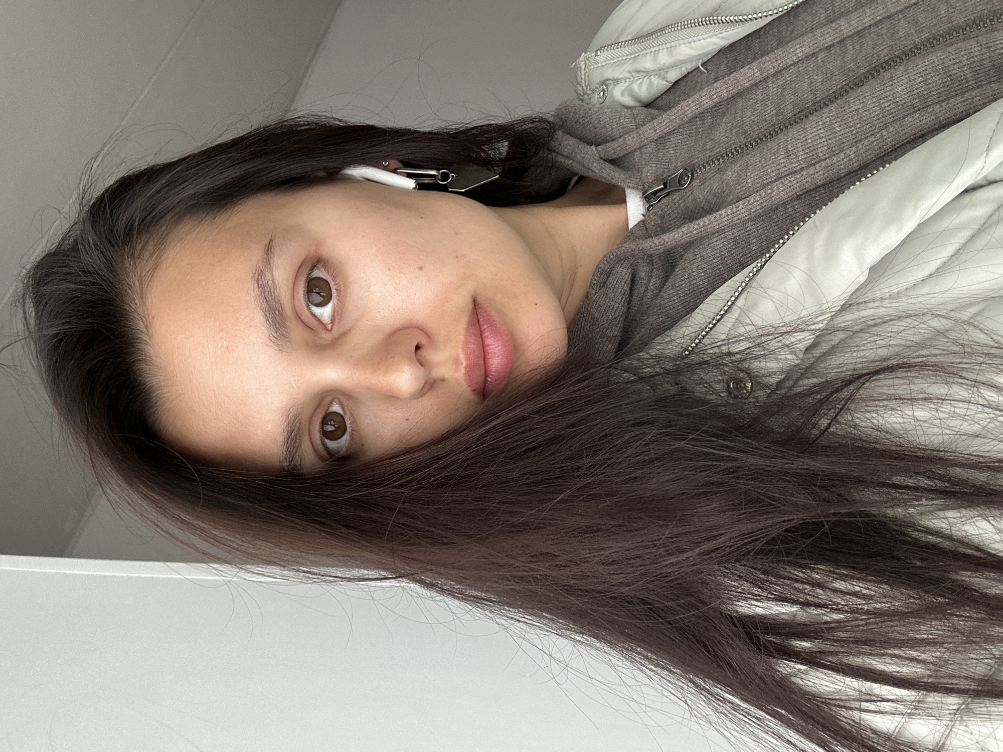 Woman takes selfies with pink phone in Chaikovsky