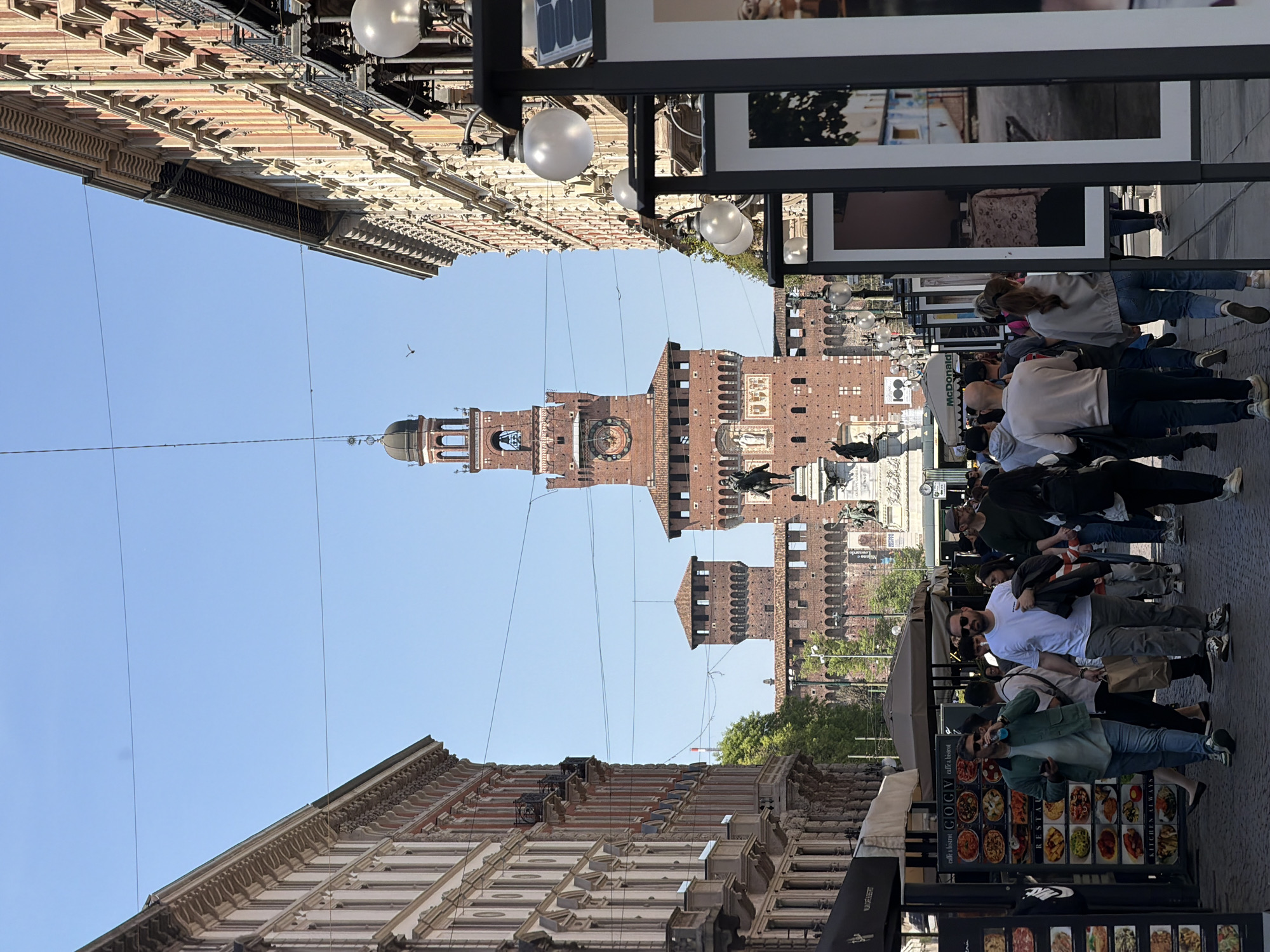 Pedestrians and vendors active near Milan's Sforza Castle