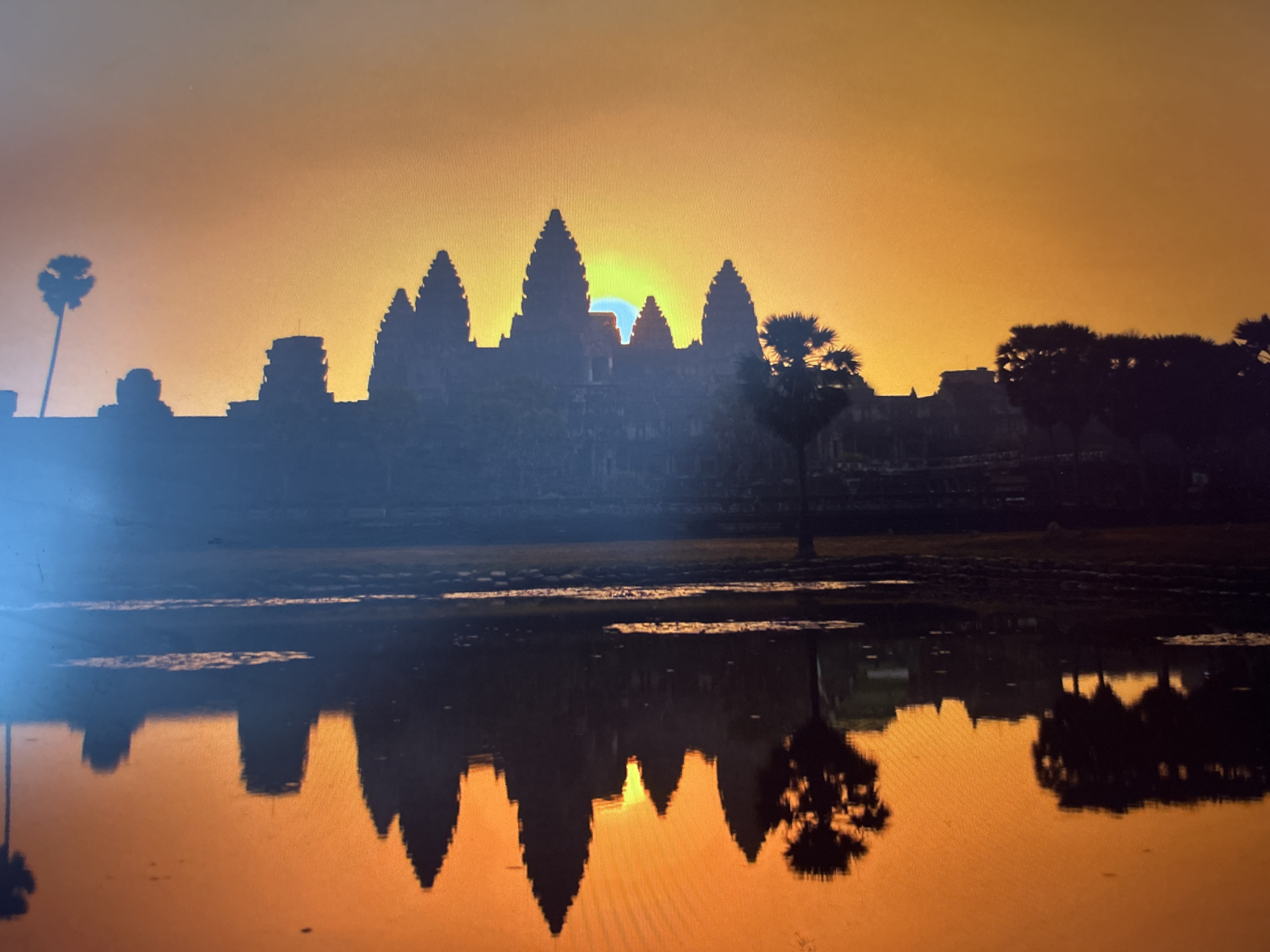 Angkor Wat's five towers rise in silhouette at sunrise