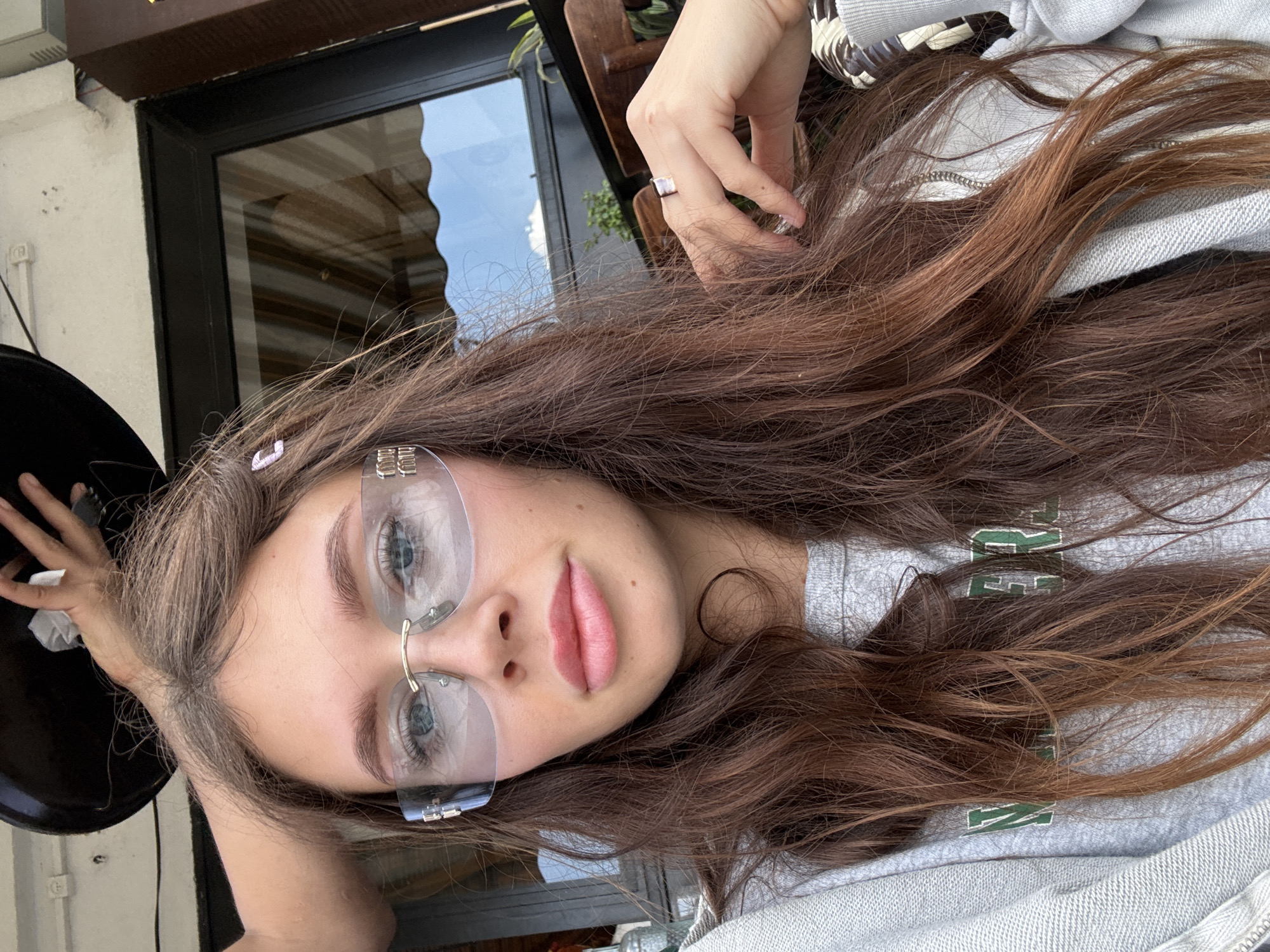 Woman observed at outdoor cafe, May 16 2026