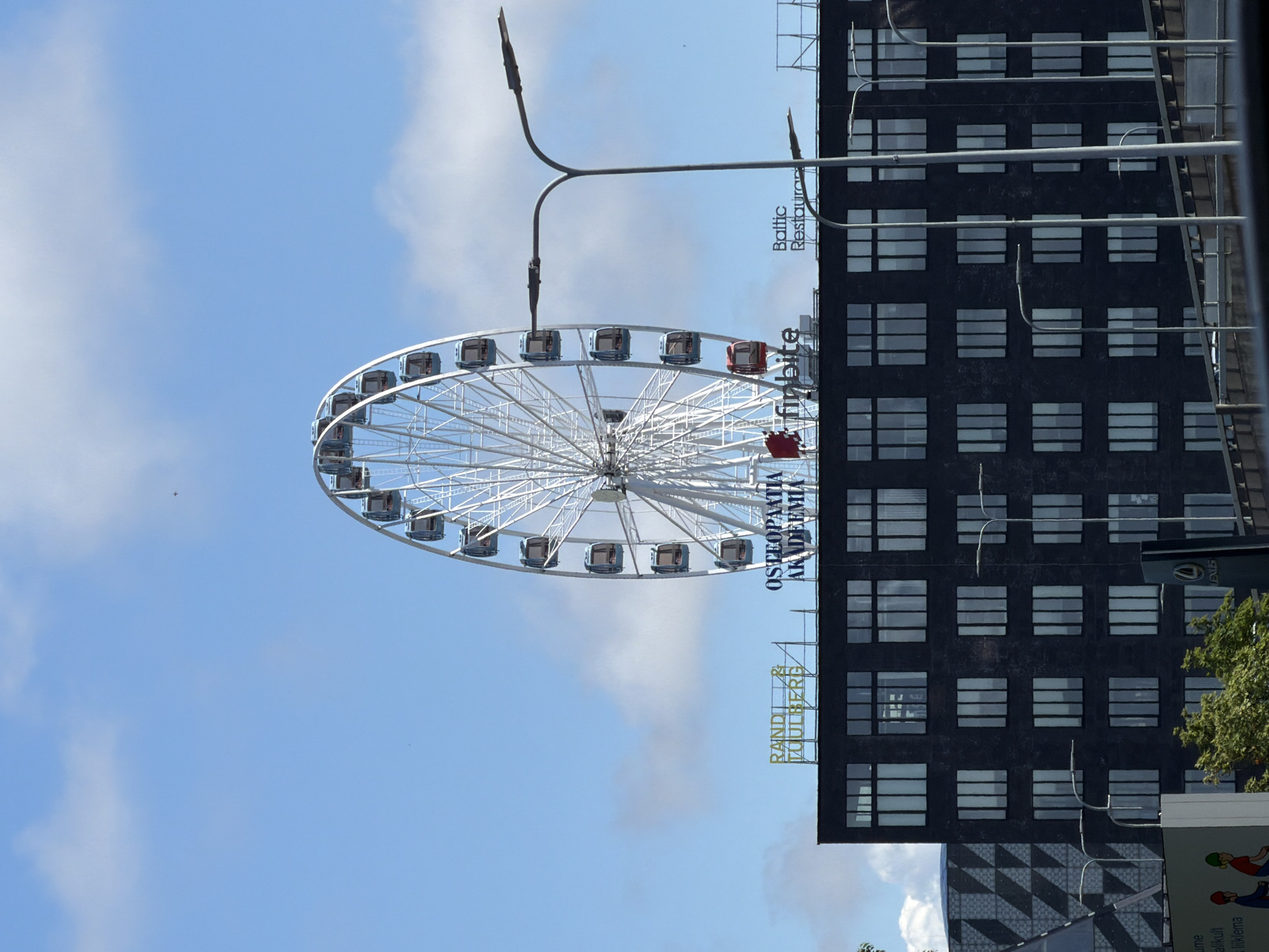 Ferris wheel and industrial chimney share Tallinn's mixed skyline