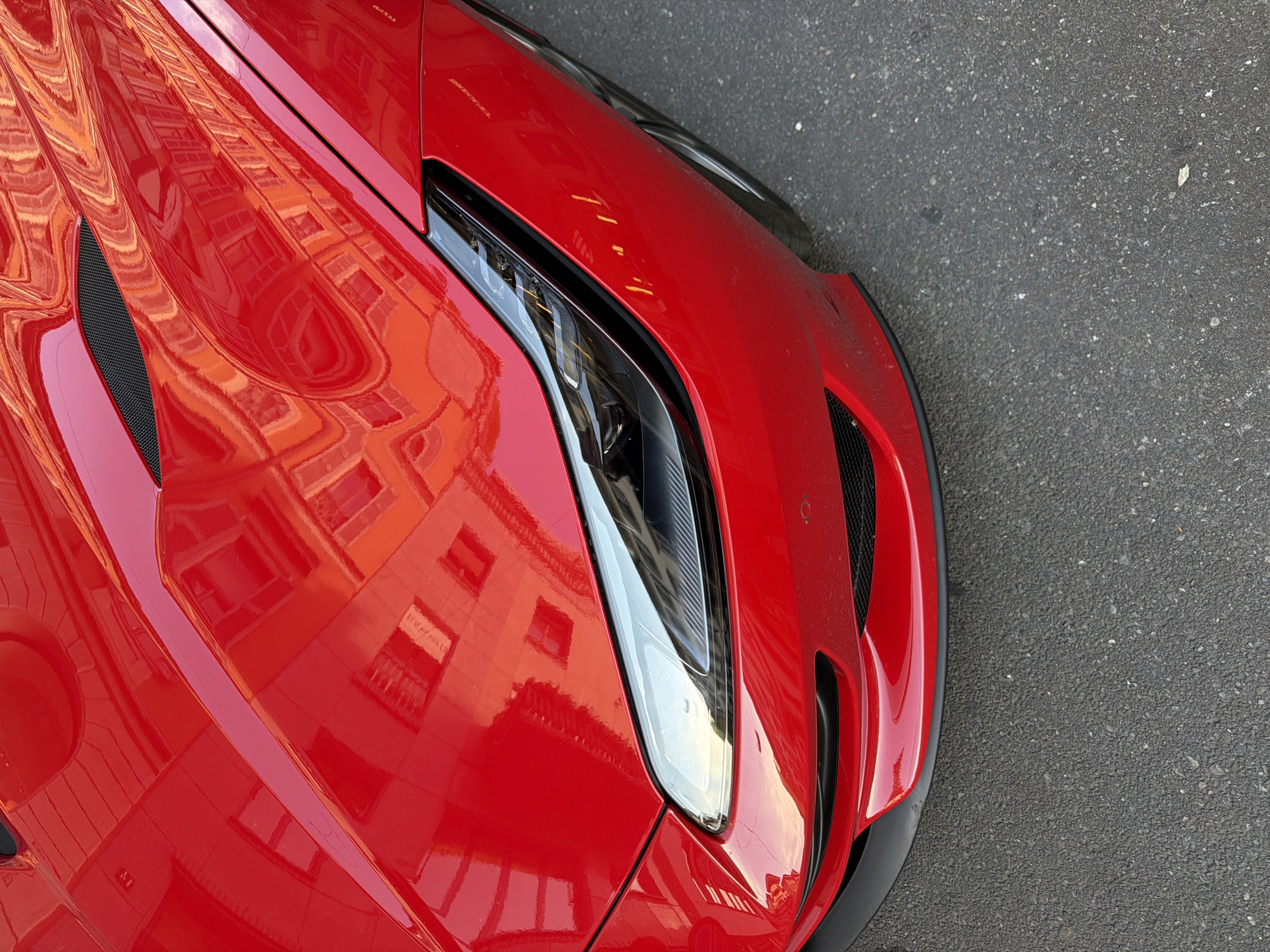 Red sports car turns heads outside Hogan during Milan Fashion Week