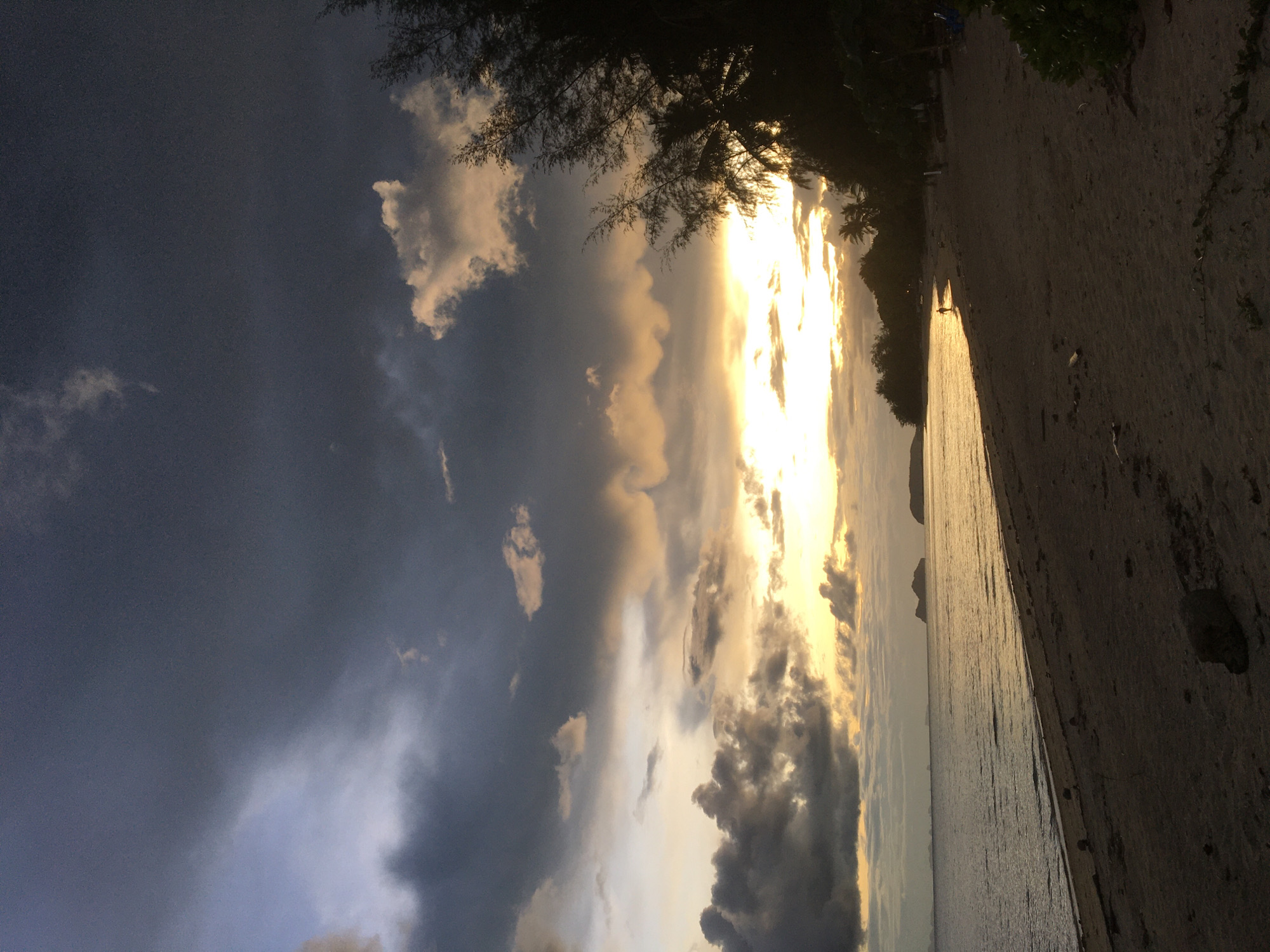 Storm clouds roll in over Ban Tai's coastline at dusk