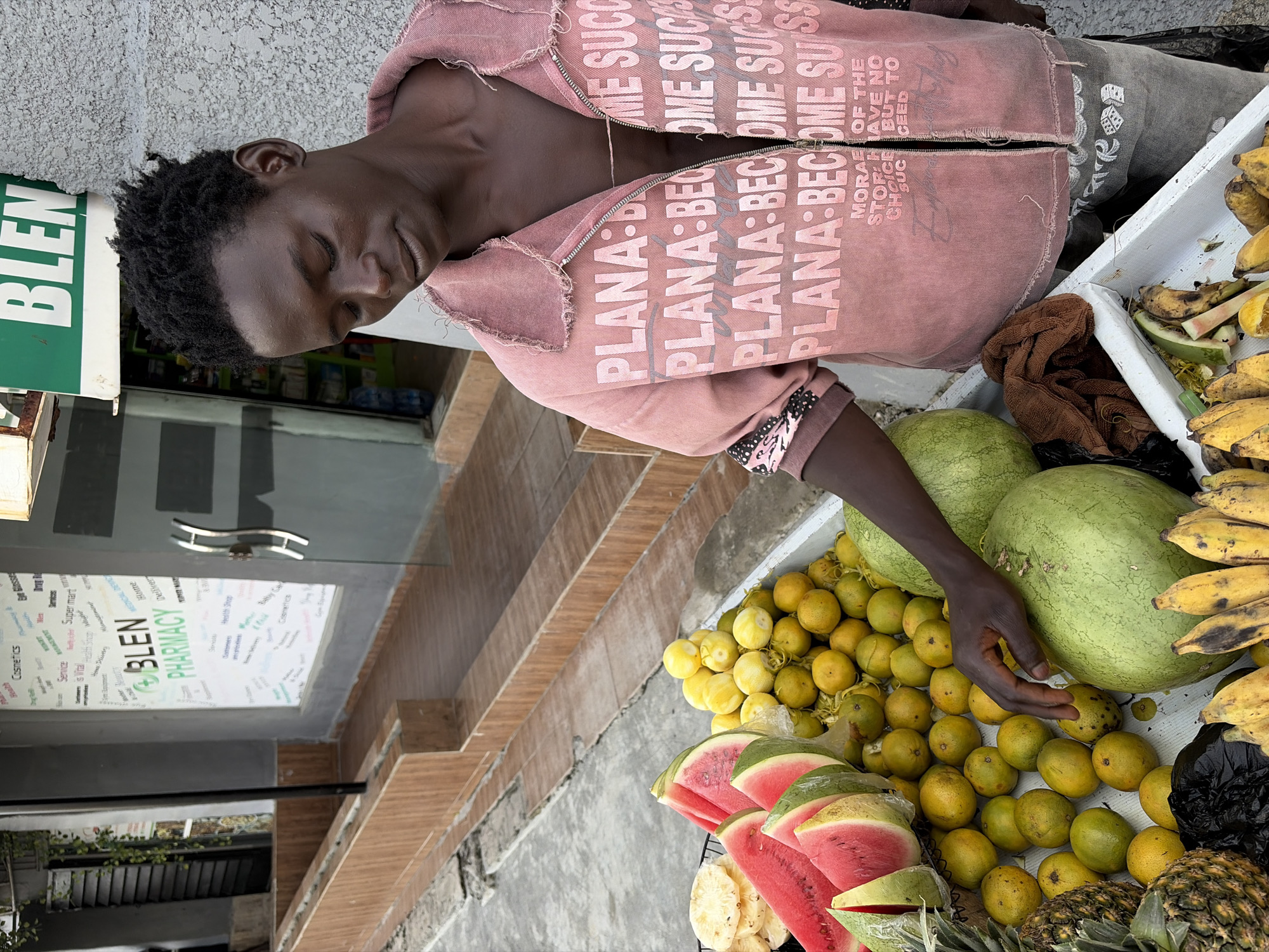 Man in motivational jacket spotted at Nigerian fruit stand