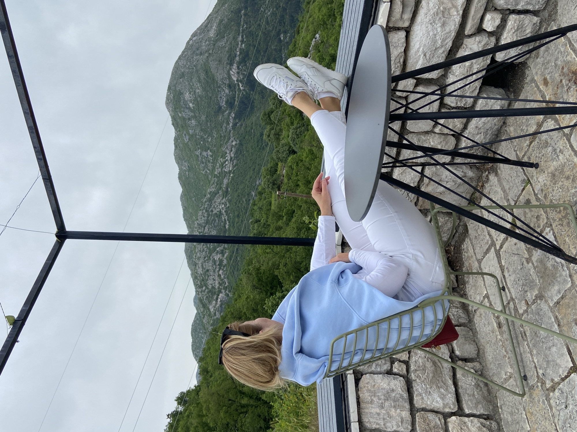 Tourist explores Montenegro mountain village via trolley and cafes