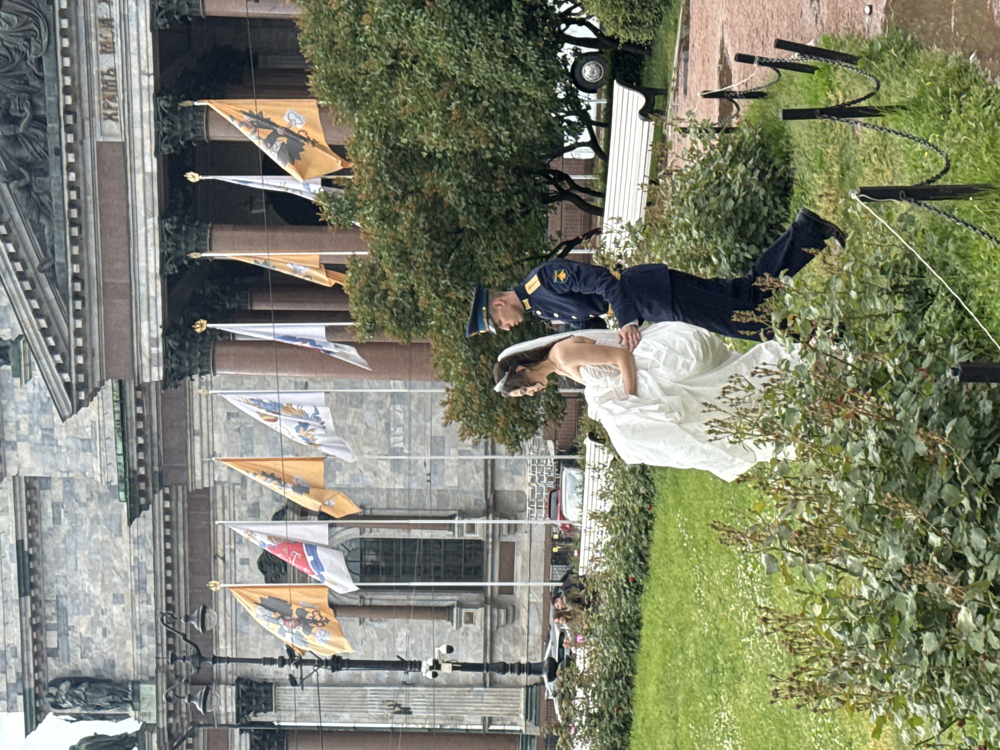Wedding celebration outside a grand classical building in Saint Petersburg