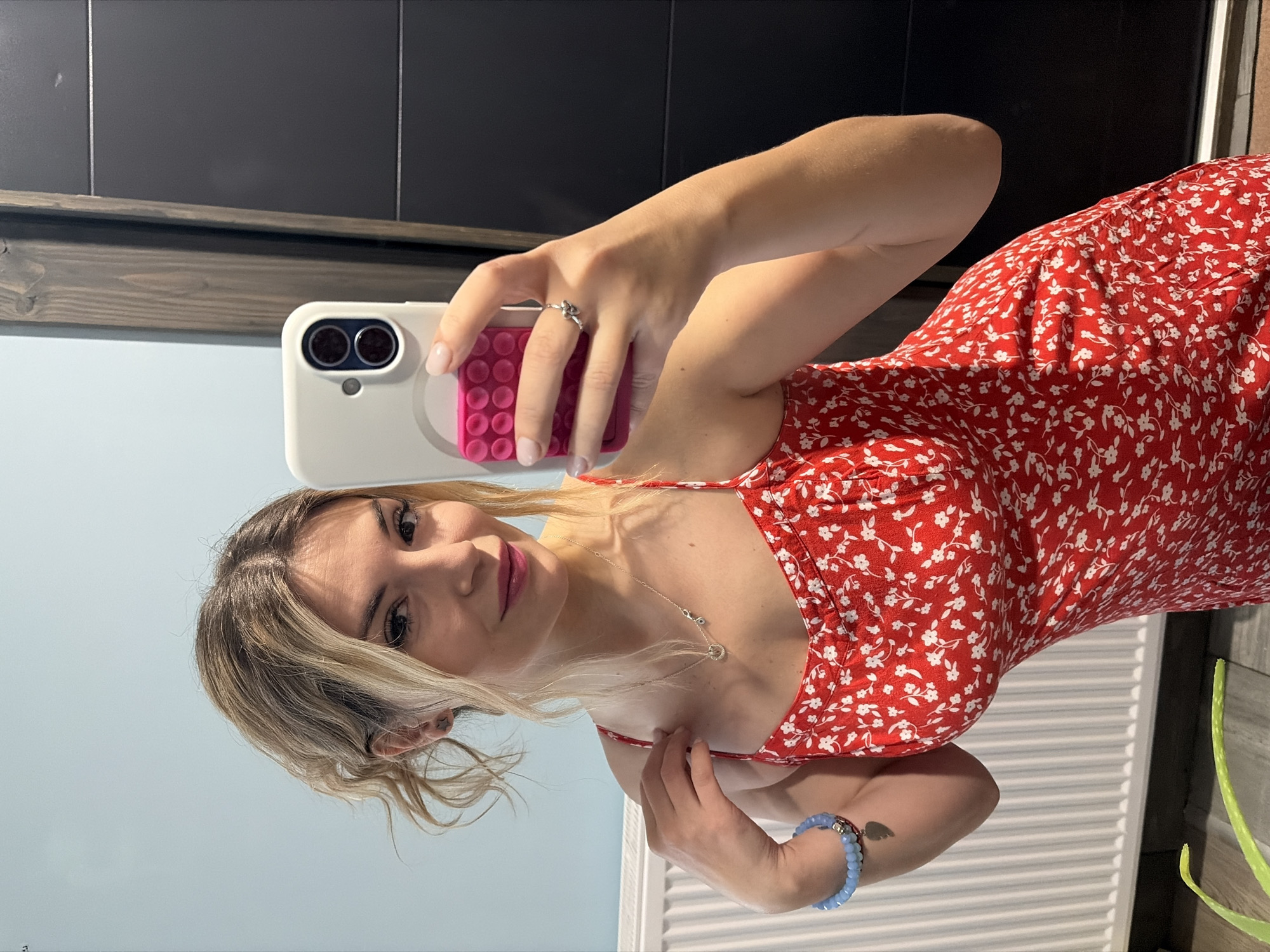 Woman takes selfie in red dress, Wisła Poland