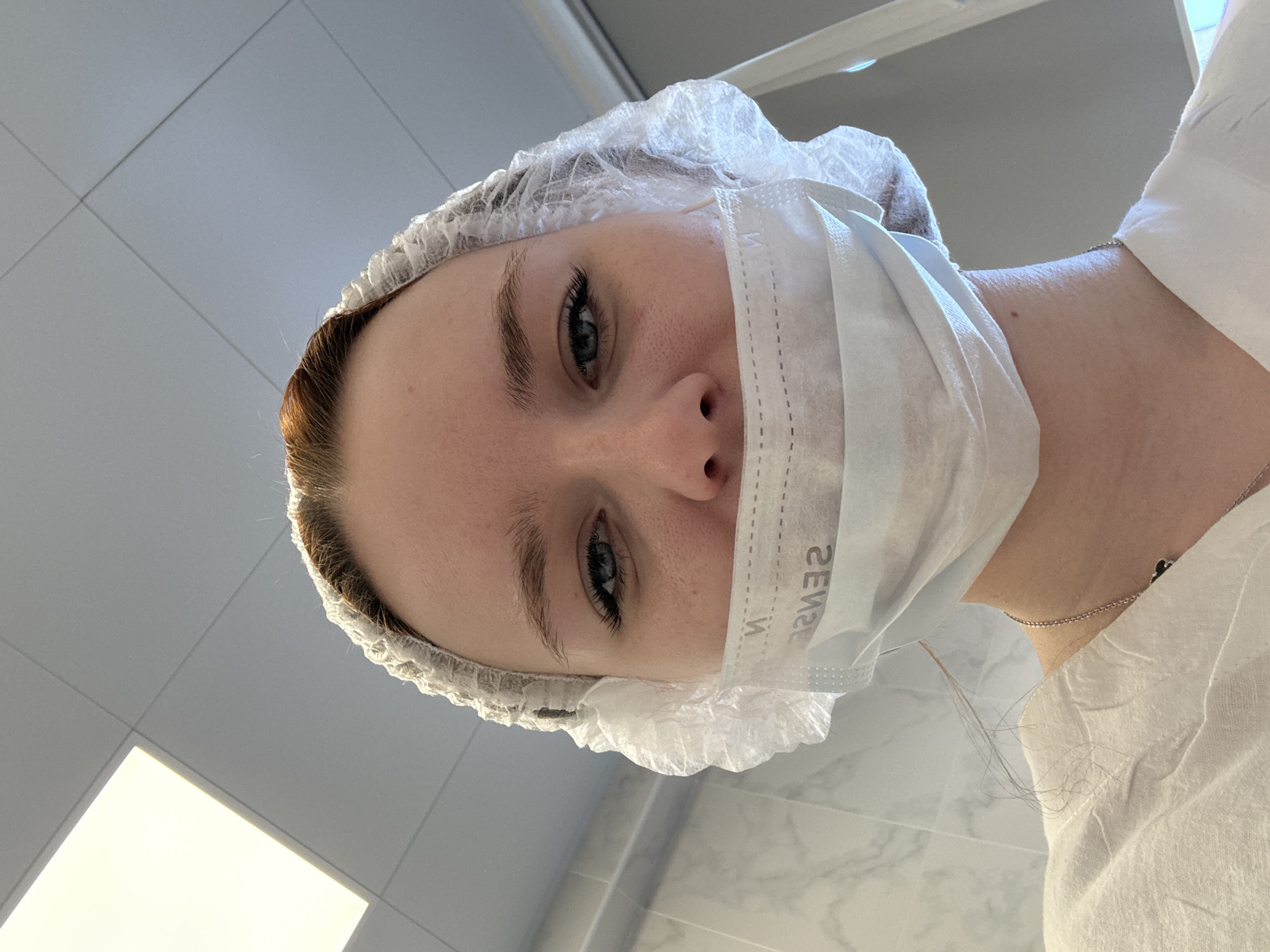 Person in medical mask with 'SENSE' text spotted in Saint Petersburg