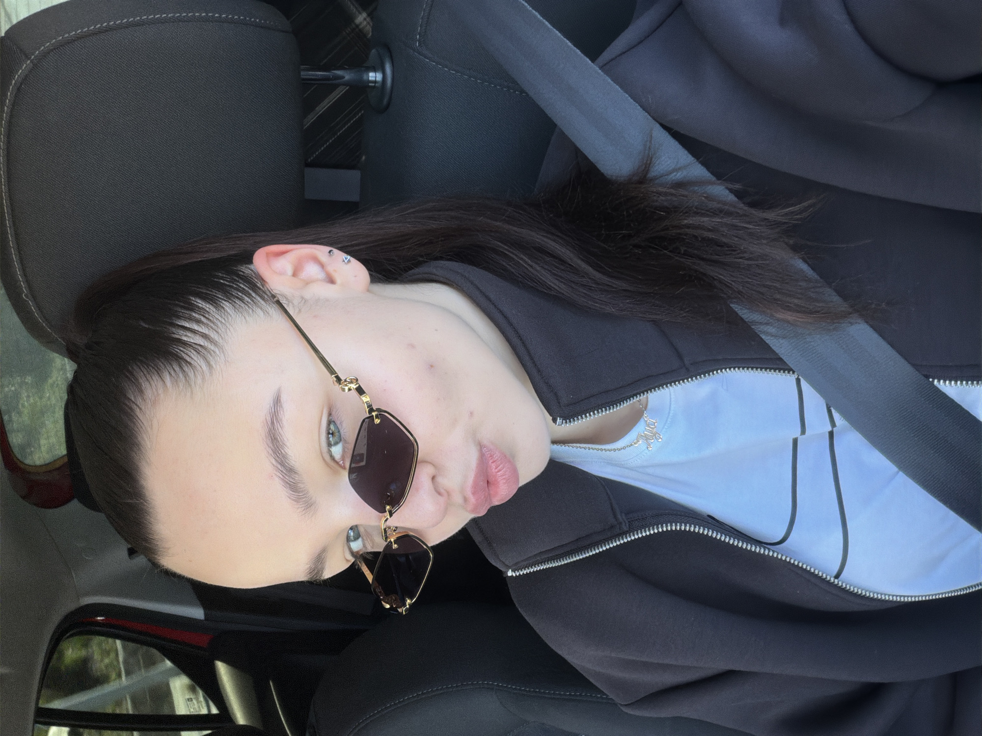 Woman photographed in car wearing sunglasses in Pernik