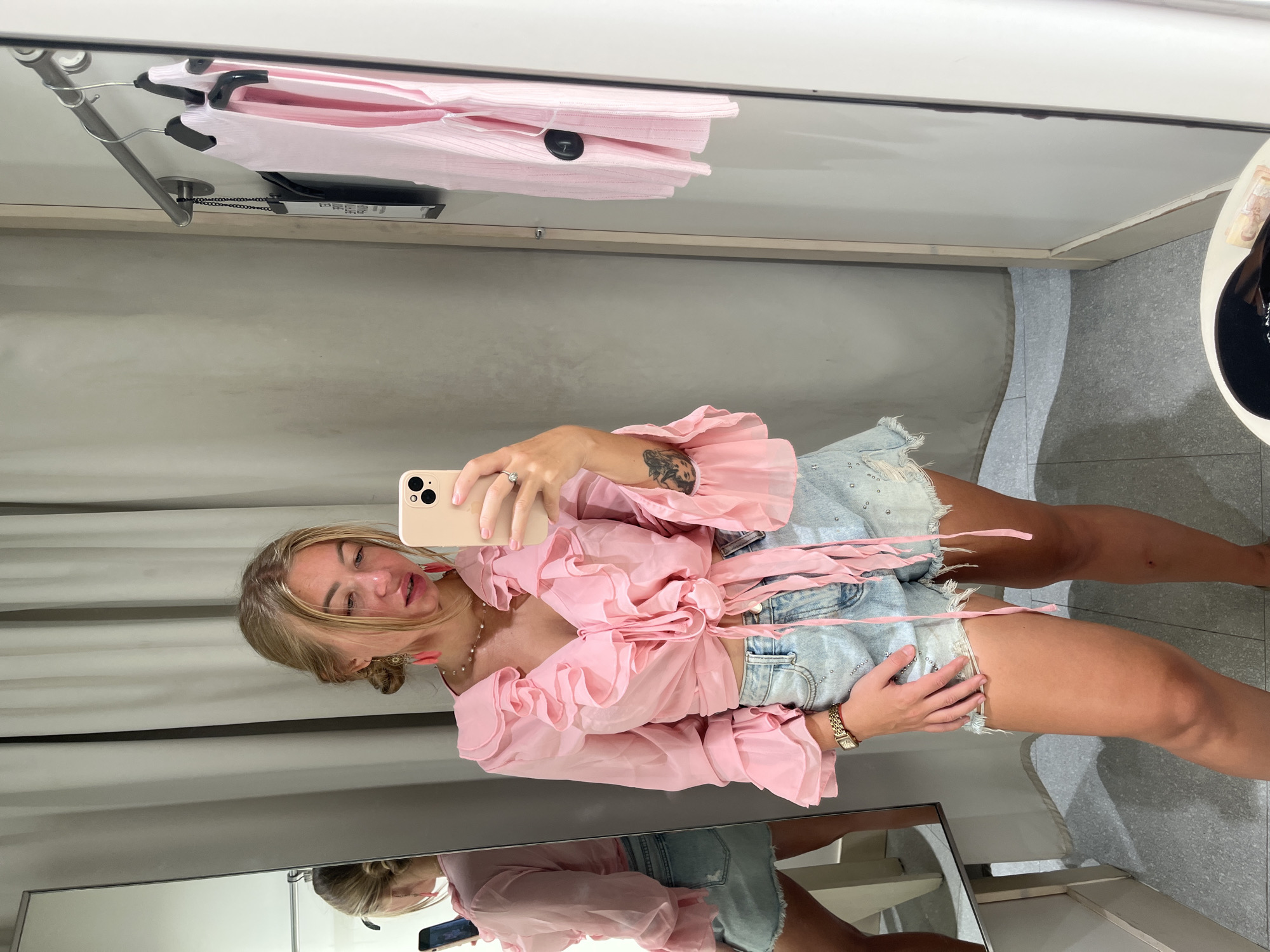 Woman takes selfie in retail changing room in Thailand