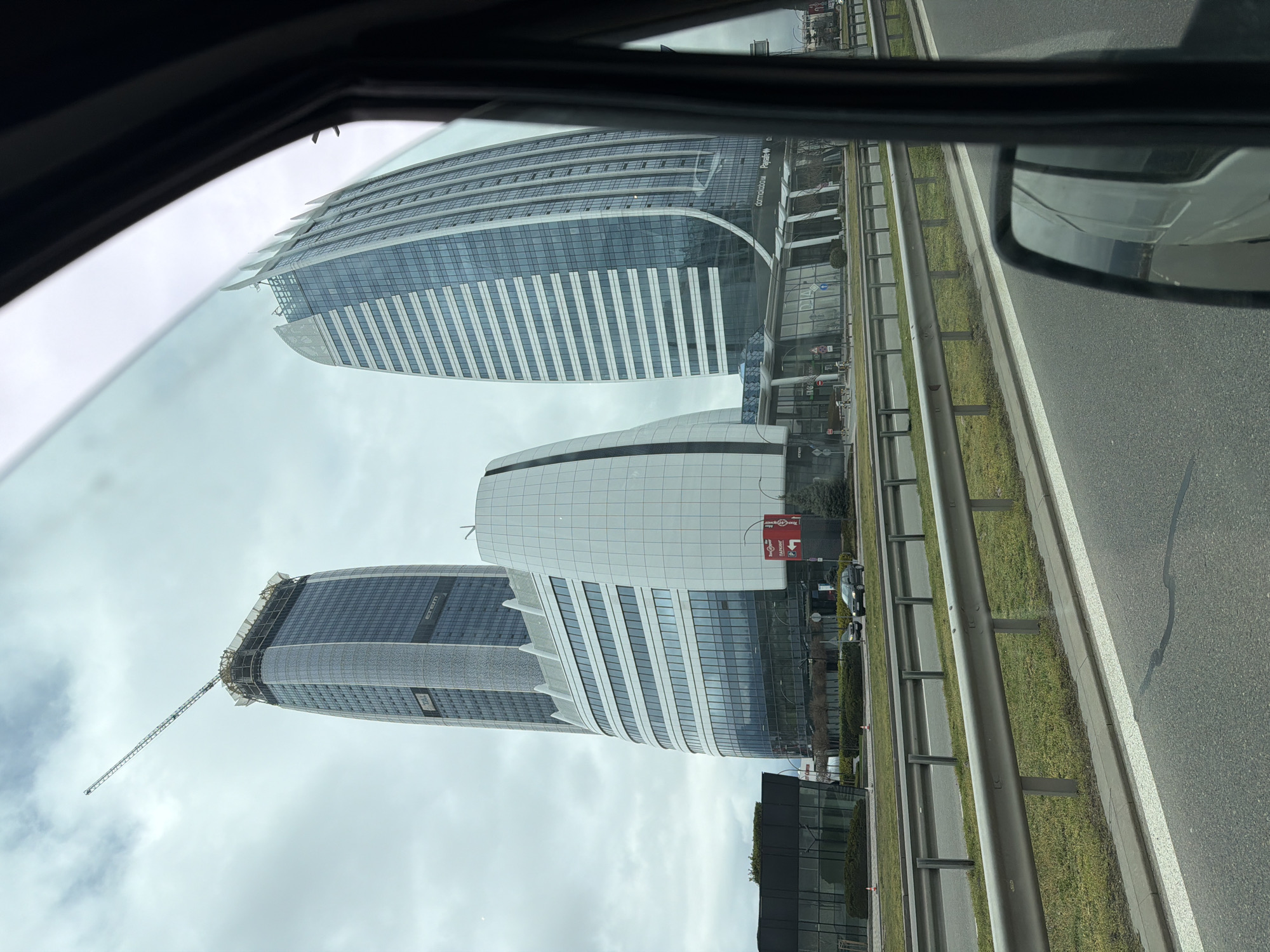 Vehicle passenger views Sofia Airport Center buildings from road