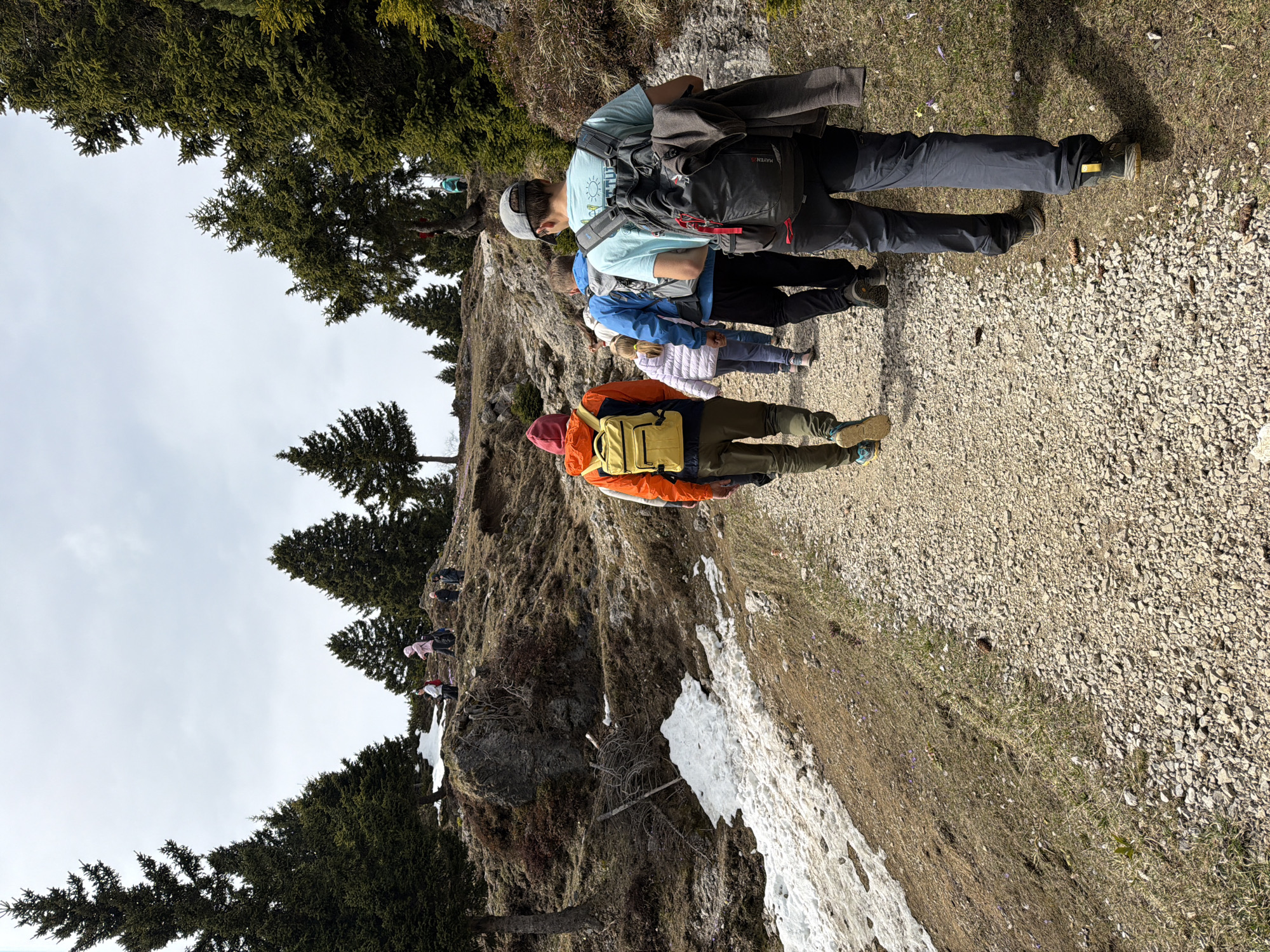 Family hikers ascend mountain trail near Kamnik, Slovenia