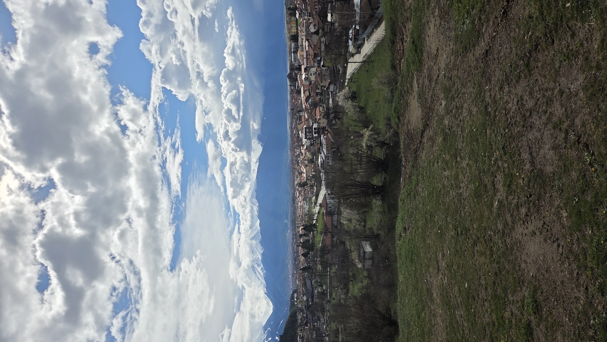 Panoramic view captured of Bulgarian town beneath snow-capped mountains