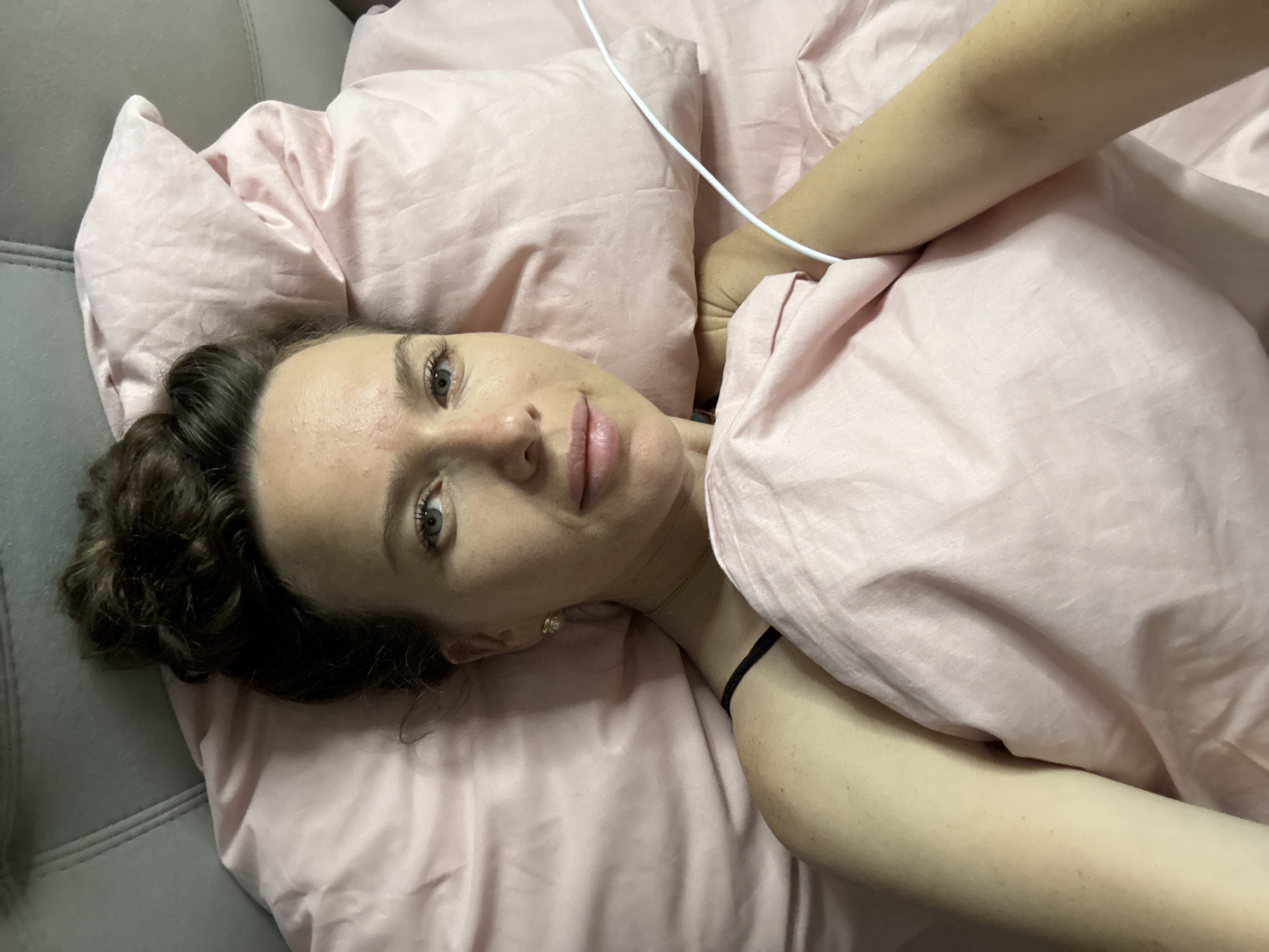 Woman photographed in bed during early morning hours in Dvoriki