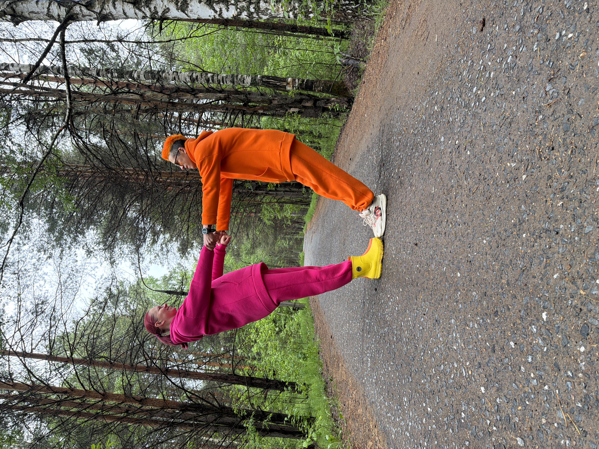 Couple in bright tracksuits share playful moments in Russian park