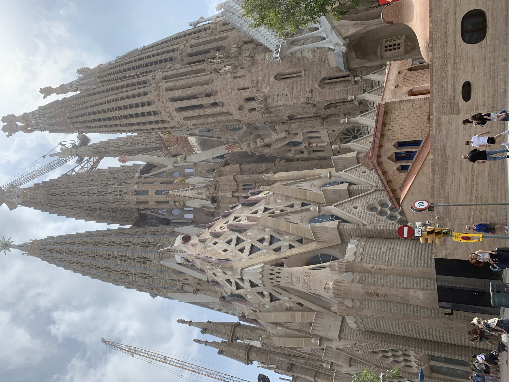 Skateboarder visits Barcelona's Sagrada Familia on sunny Tuesday morning
