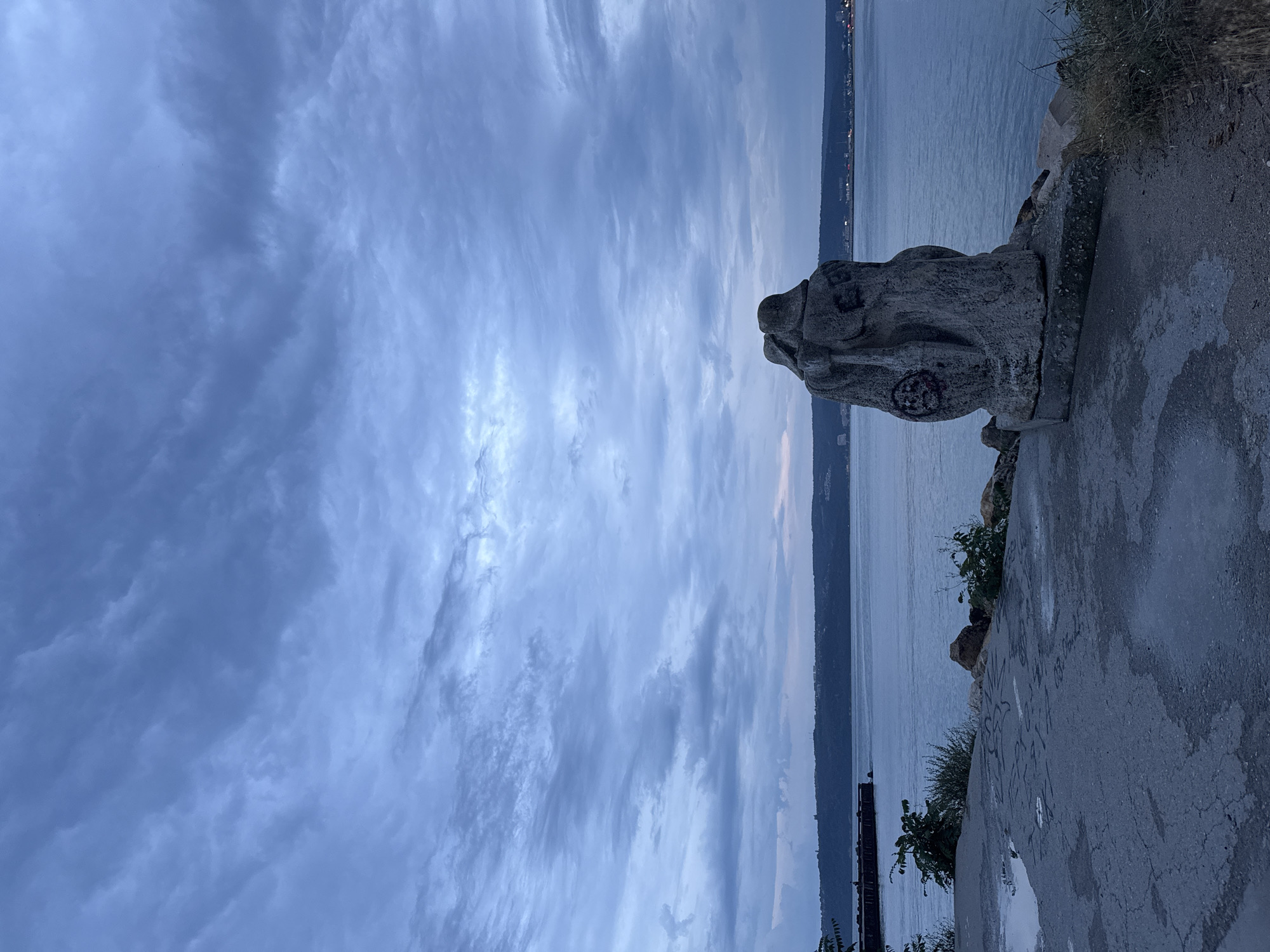 Abstract stone sculpture at Varna's Black Sea waterfront, dusk