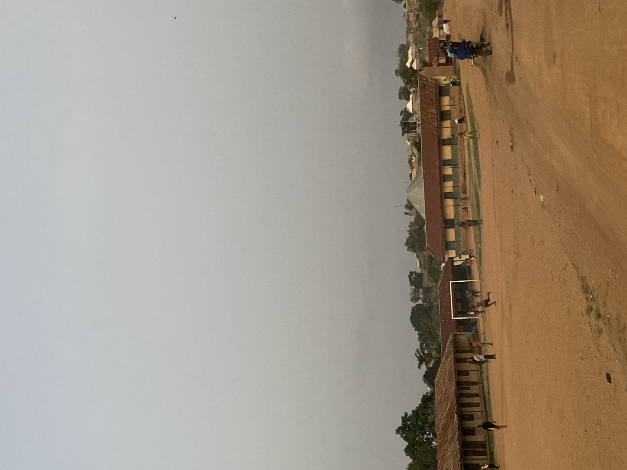Children play soccer, walk barefoot in rural Nigerian village