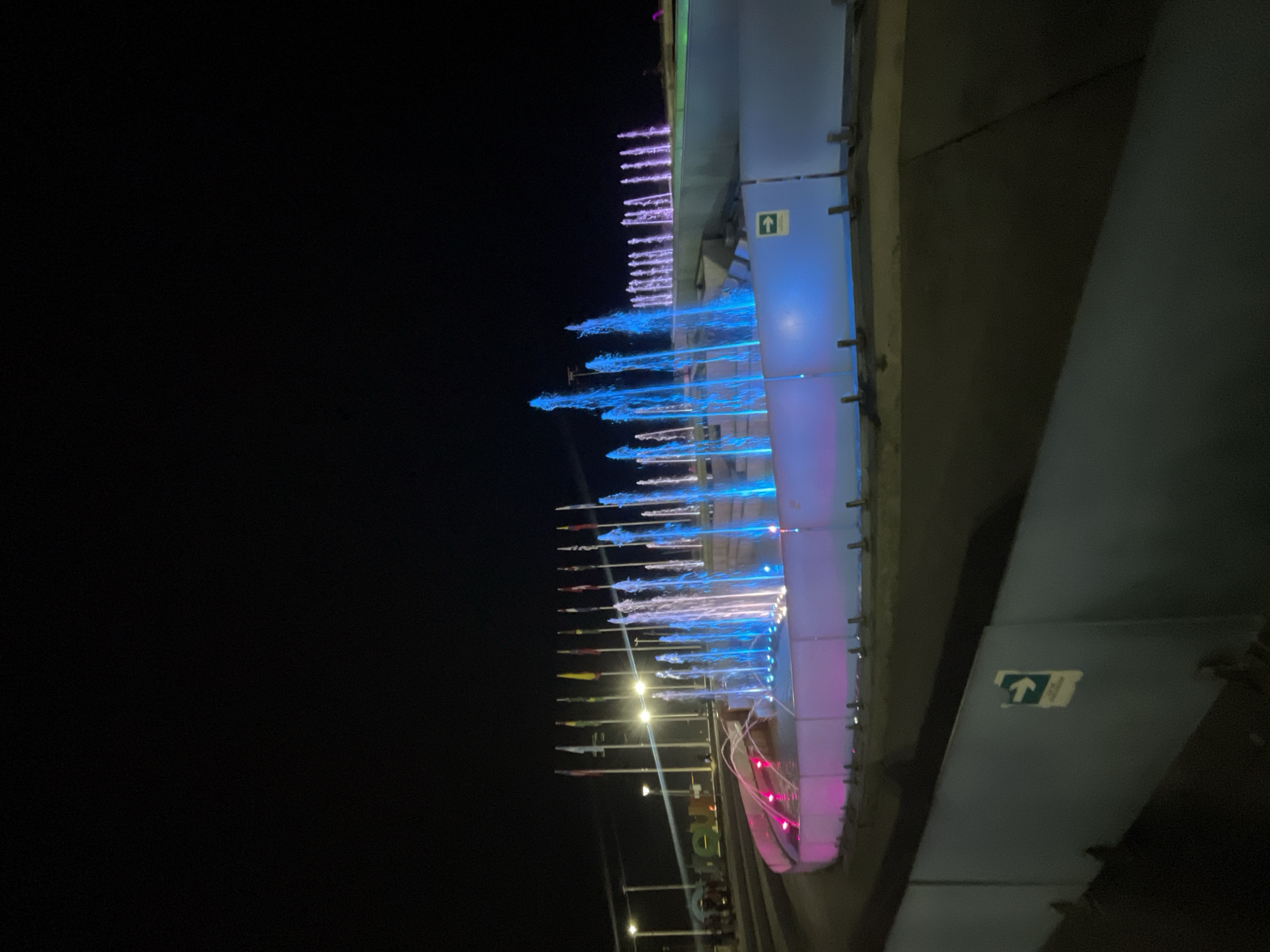 Illuminated fountain operates at night in Iquique pedestrian area