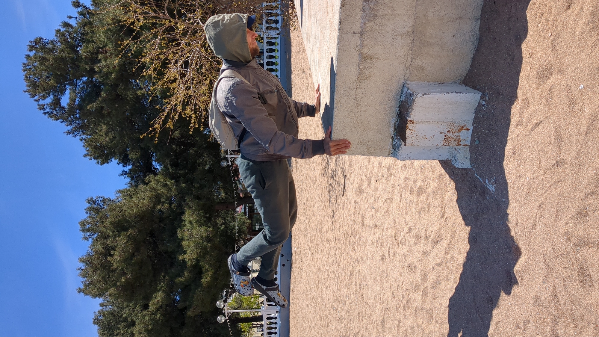 Man leans against concrete structure in sunny Gelendzhik