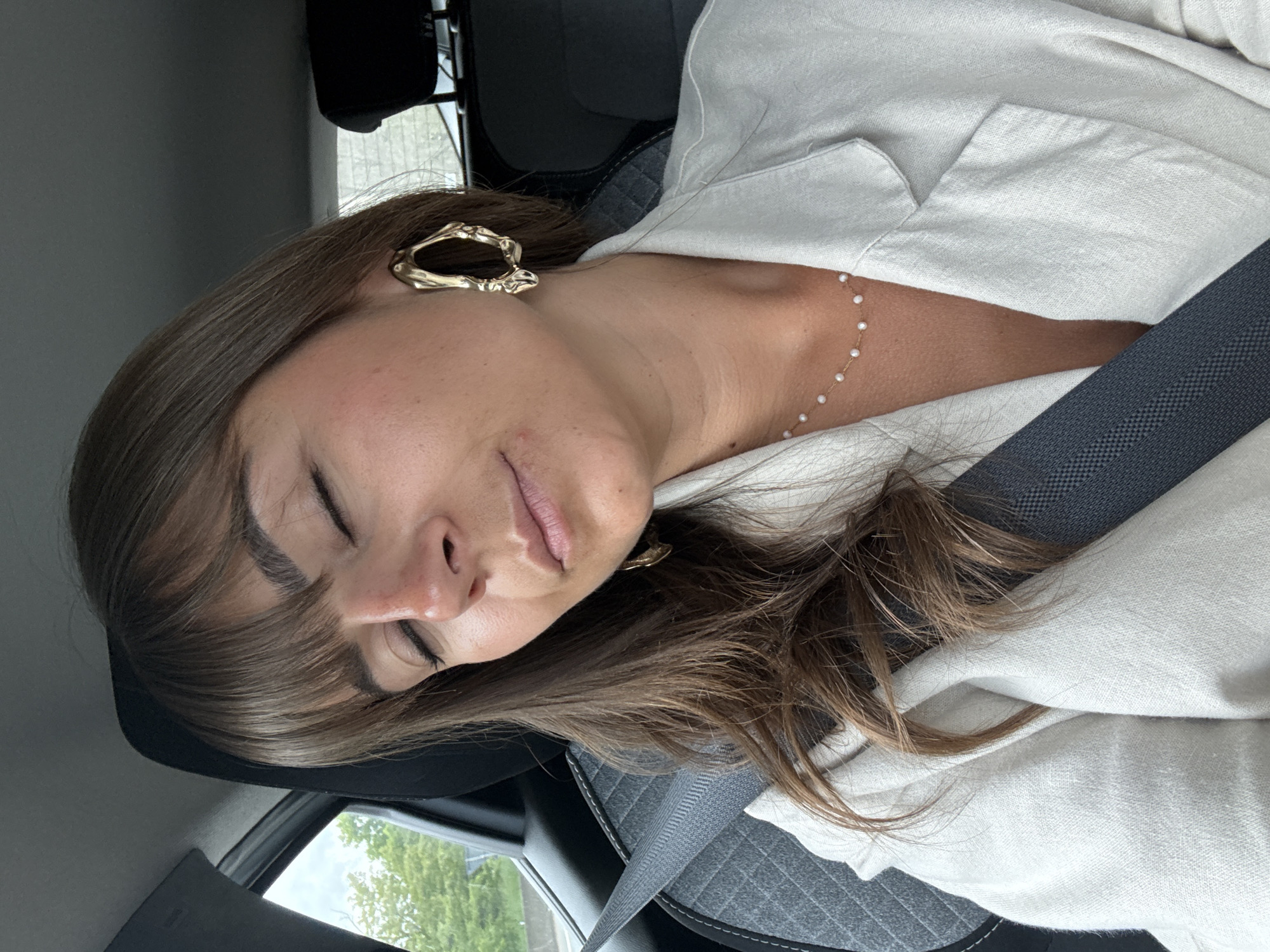 Woman rests in moving car in Saint-Étienne