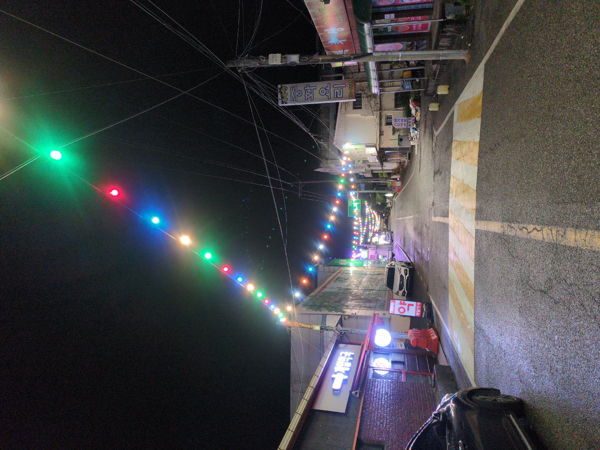 Nighttime street photography documents illuminated Iwon, South Korea scenes