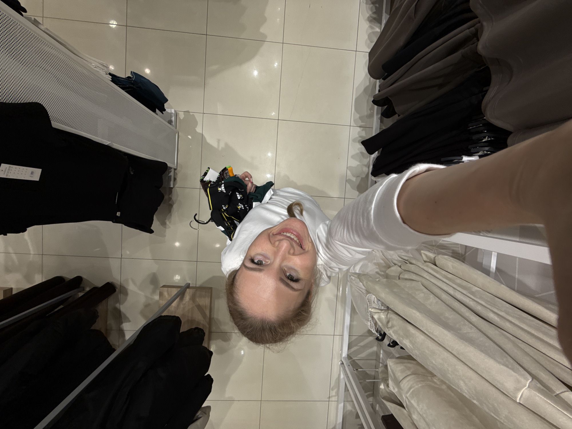 Woman takes shopping selfies in Chaikovsky clothing store