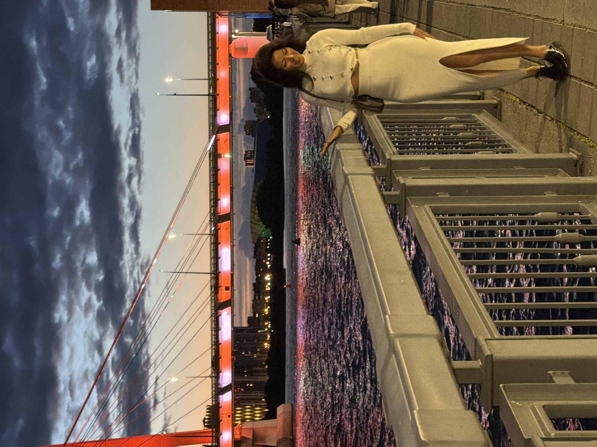 Waterfront evening: lit bridge, sunset views, and city energy