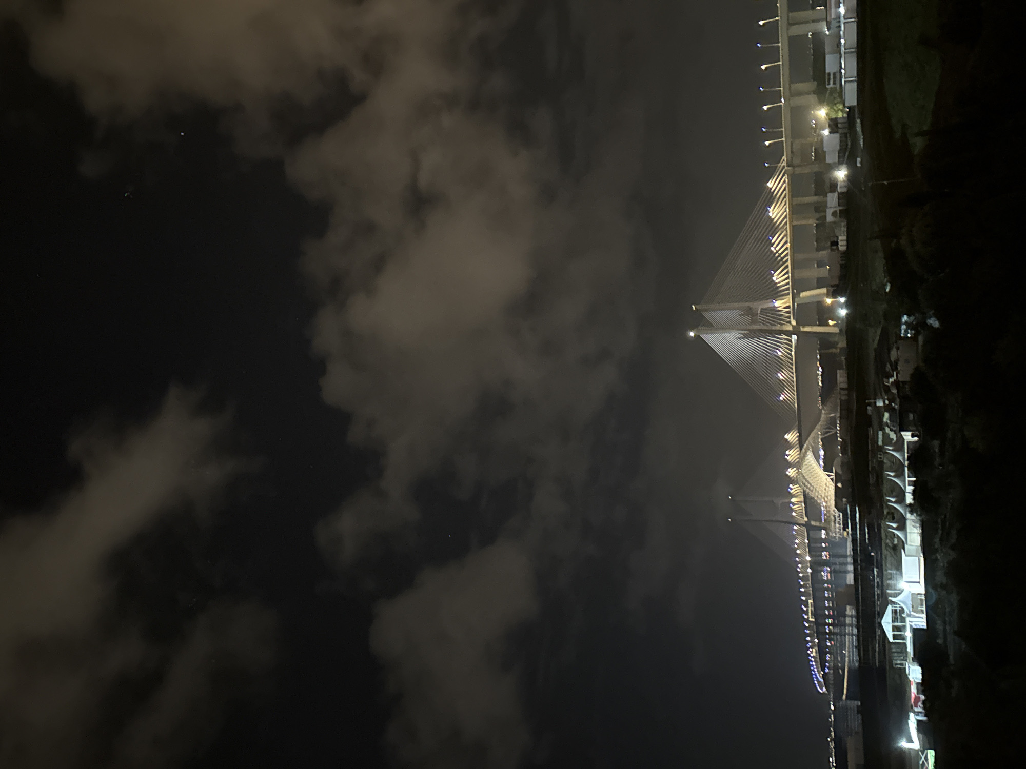 Illuminated bridge lights up night sky in Loures, Portugal