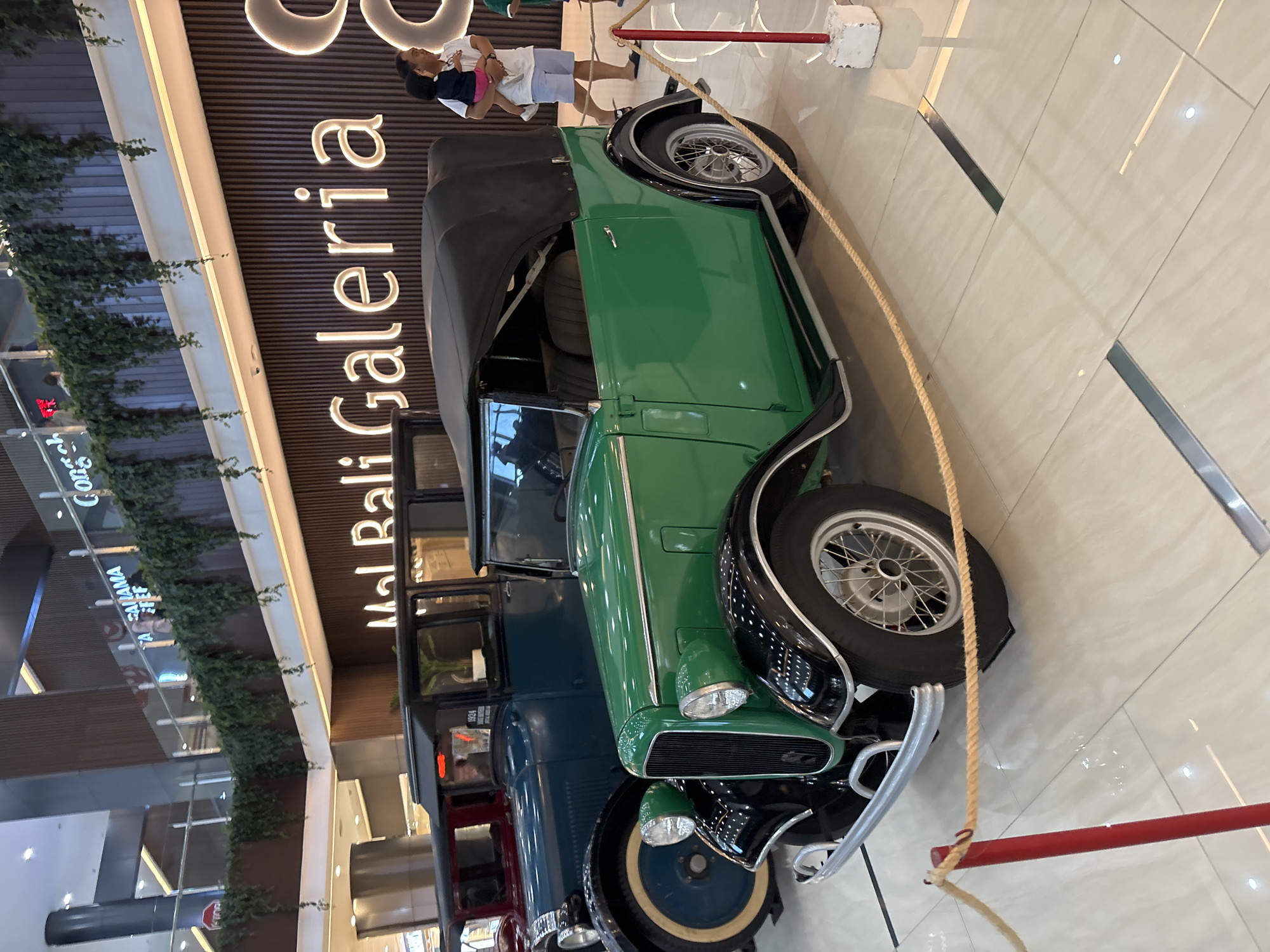 Vintage car exhibition displays classic automobiles at Kuta shopping mall