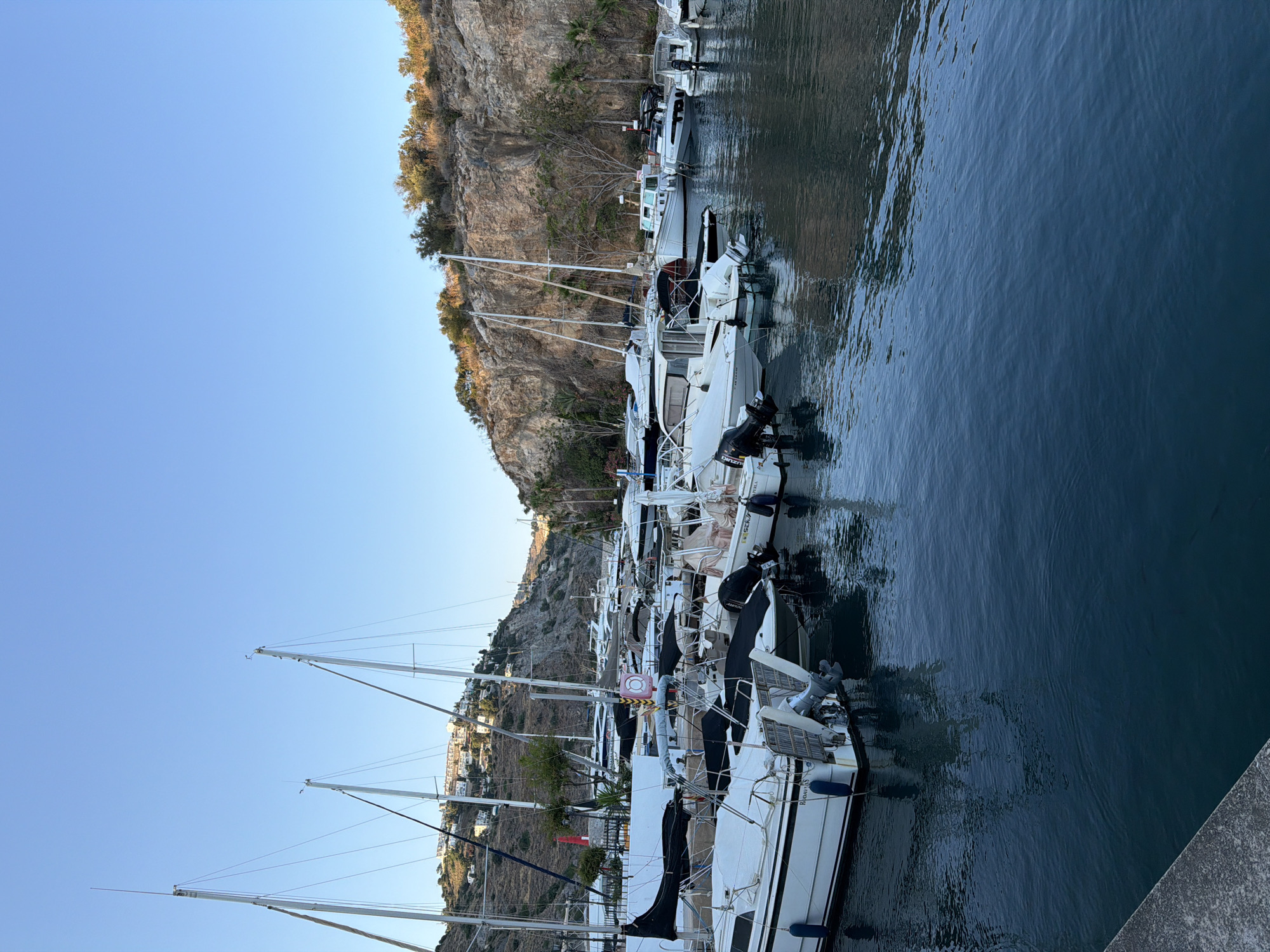 Calm evening at Almuñécar marina, boats docked on still water