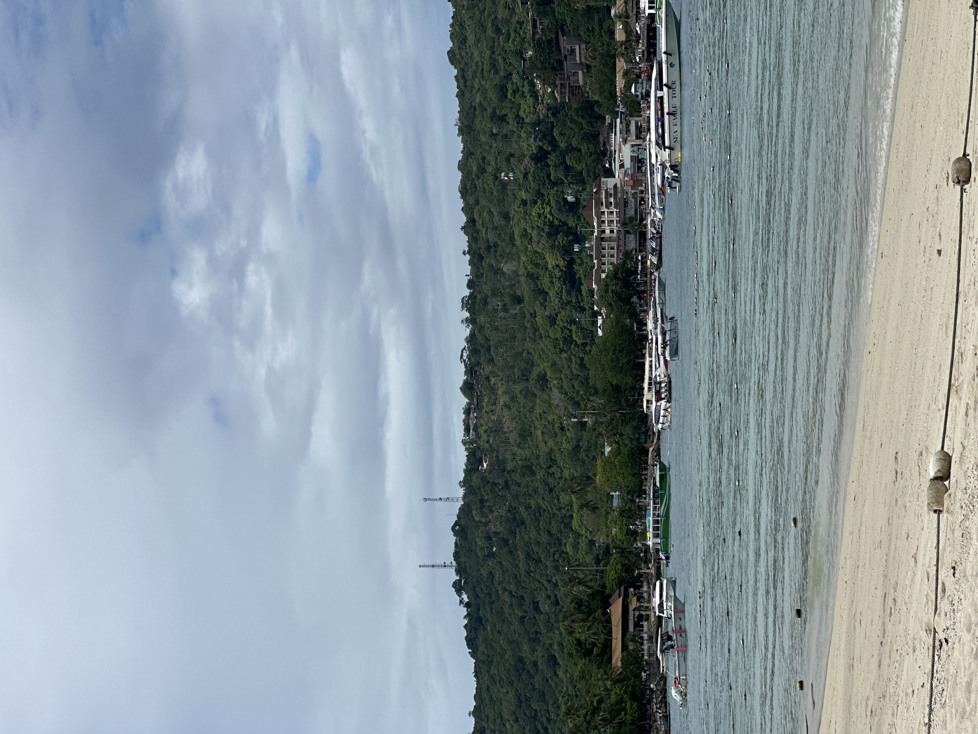 Ao Nang beach on a quiet morning, boats and limestone cliffs