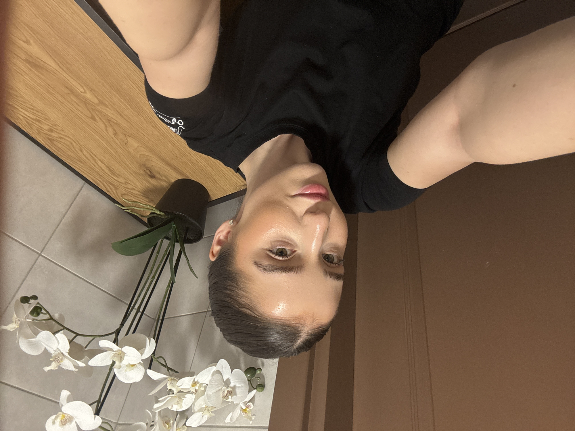 Woman takes selfie in black t-shirt