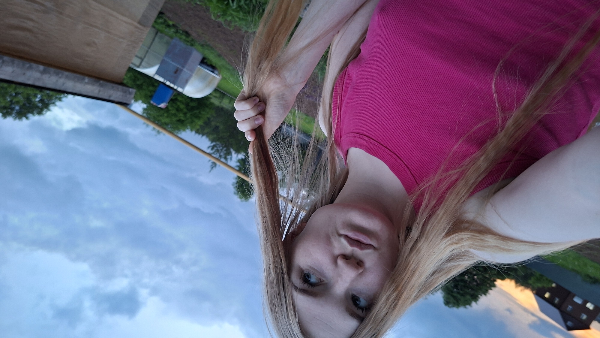 Young Woman Documents Evening Garden Photography Session in Rural Russia