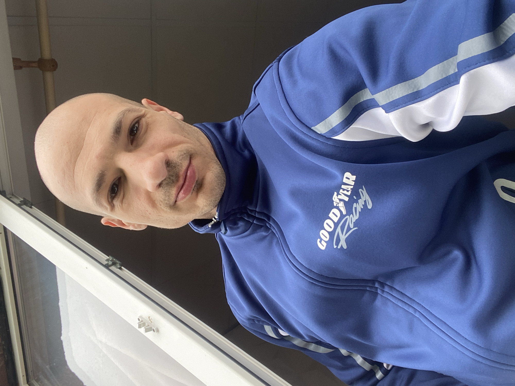 Man in Goodyear jacket photographed by window in Pleven