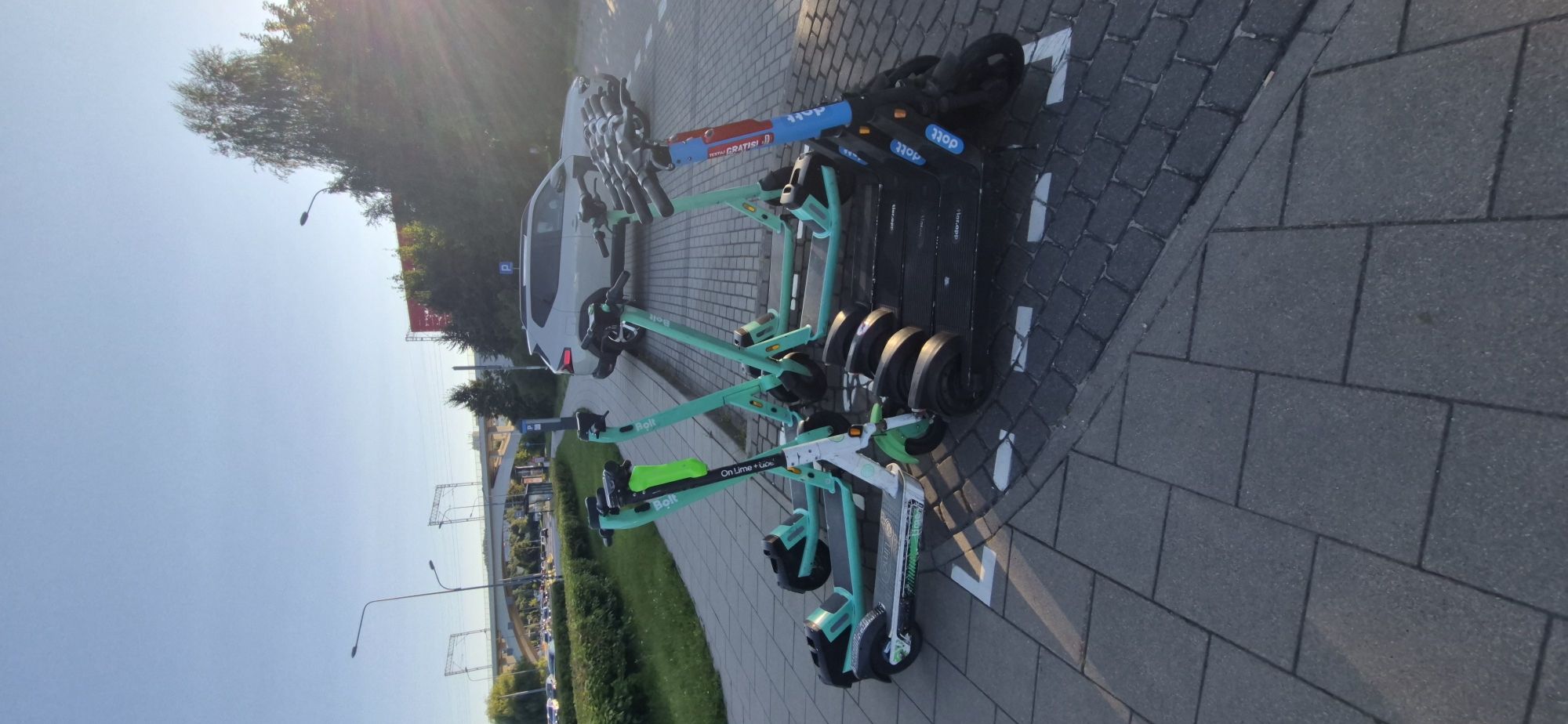 Gdańsk street-level snapshot: scooters, fuel station, modern housing