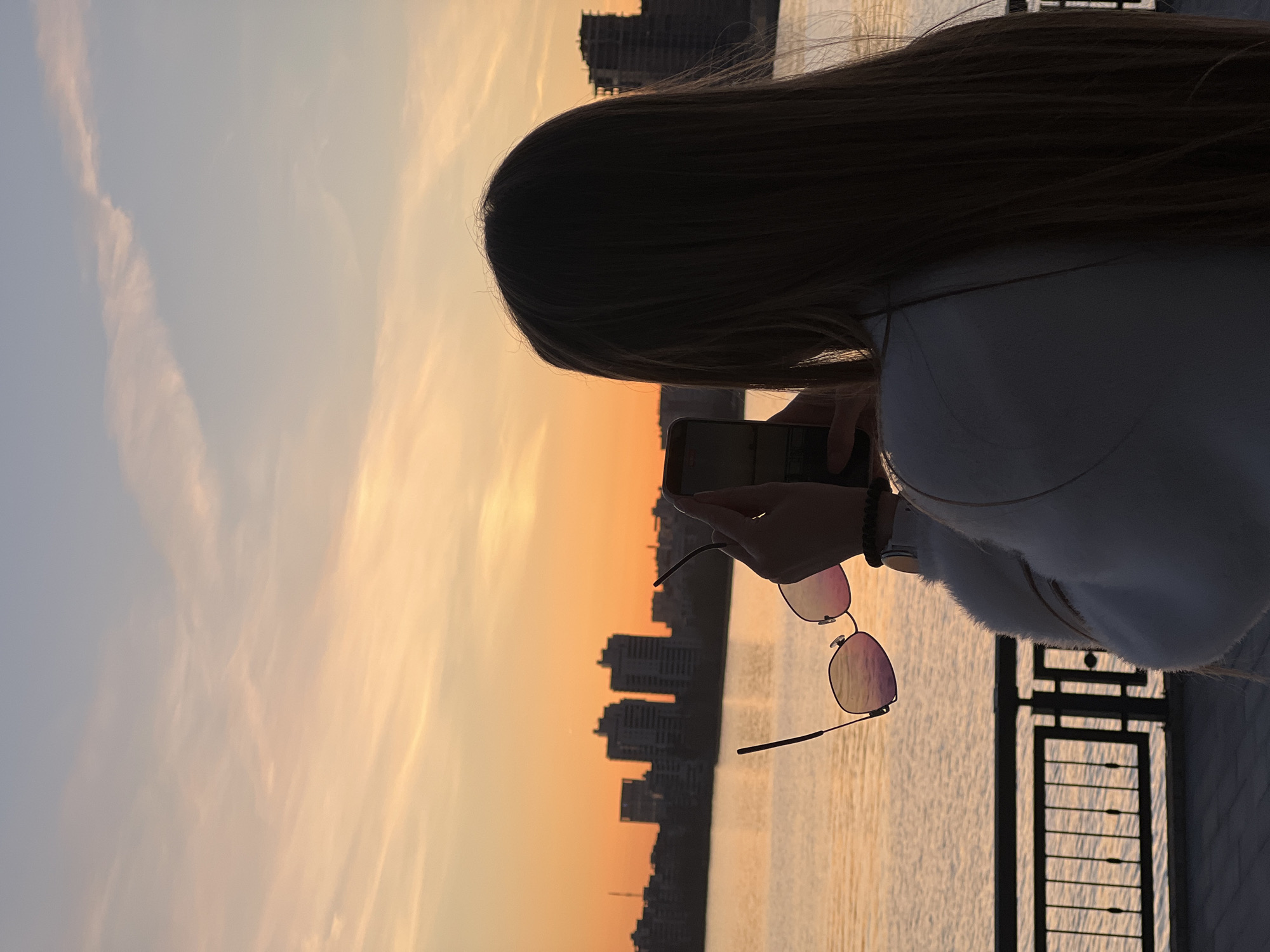 Woman watches sunset from Kazan waterfront promenade