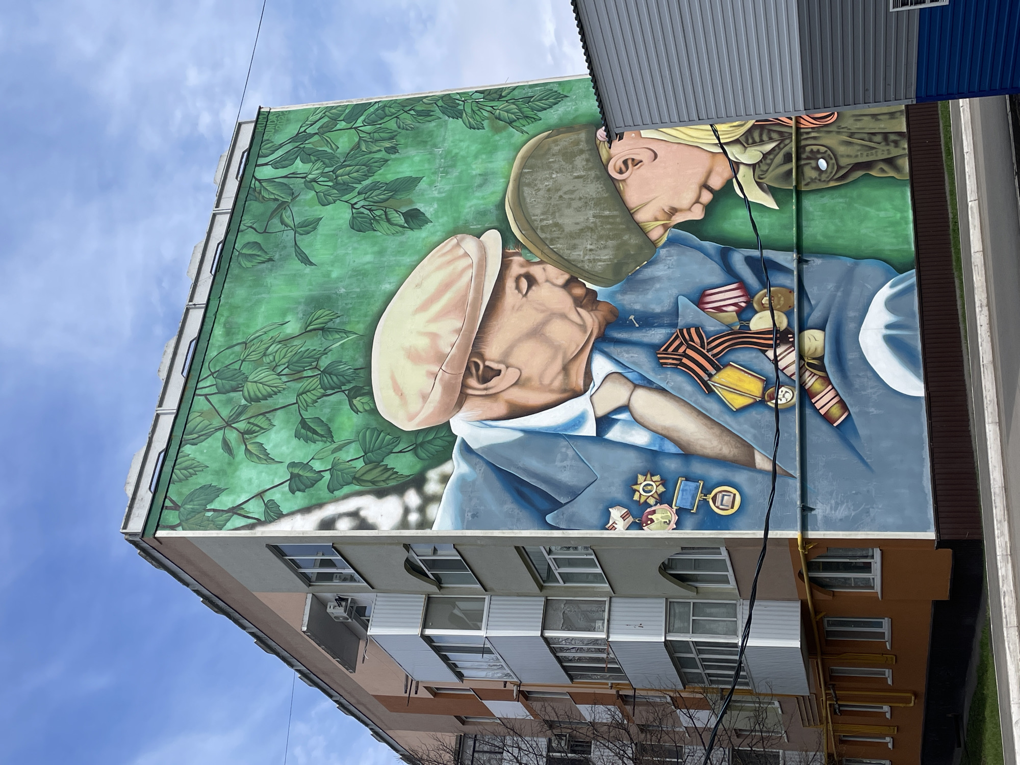 Spring blooms and memorial mural documented in Urussu, Russia