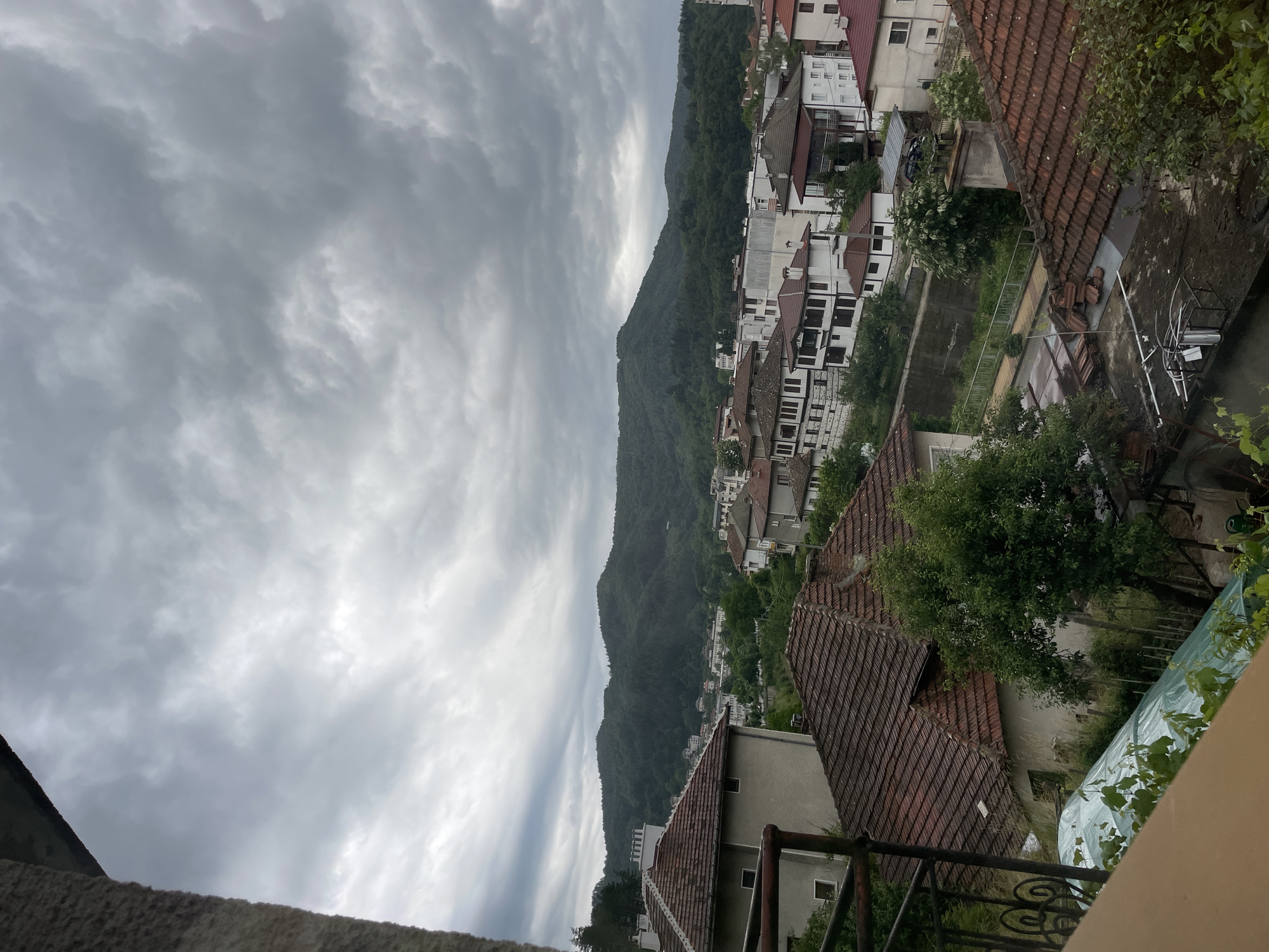 Dramatic clouds captured over Bulgarian mountain town from balcony