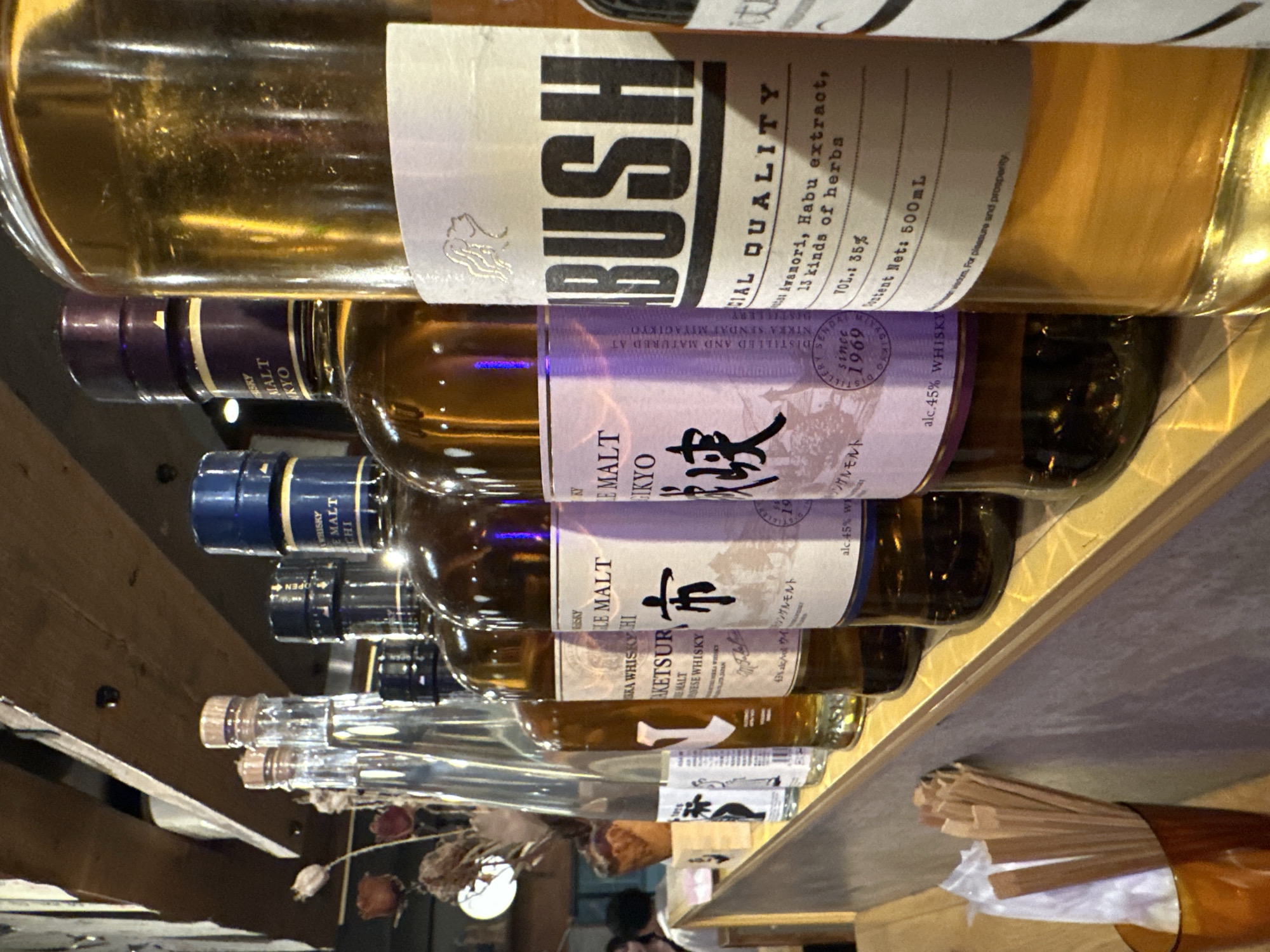 Specialty alcohol bottles with herbal extracts observed in Meguro