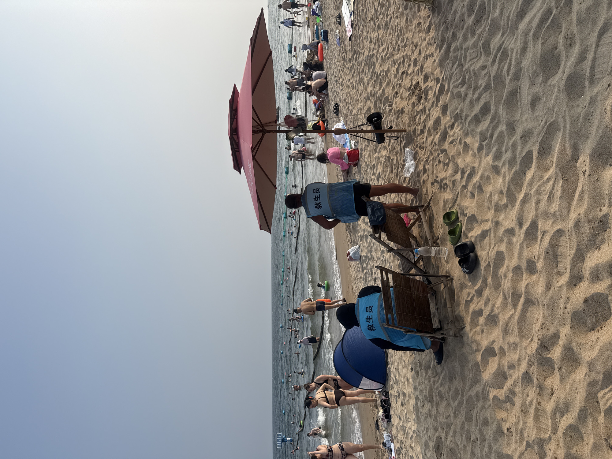 Lifeguards on duty at crowded Beidaihe beach, Qinhuangdao