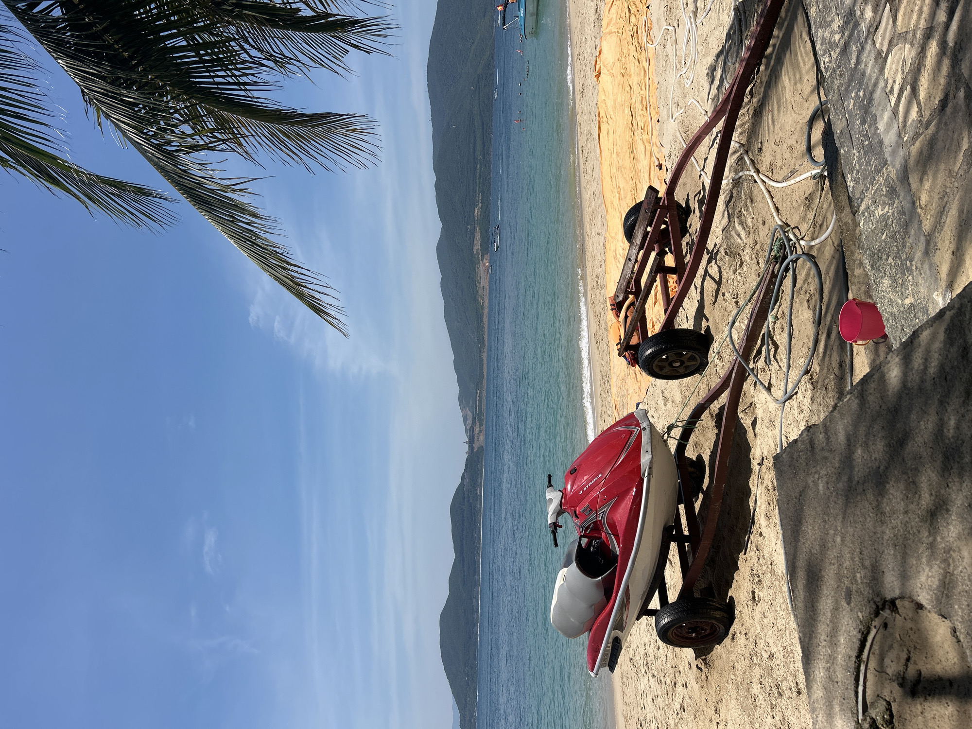 Morning at a Nha Trang beach, jet skis, palms, and small details