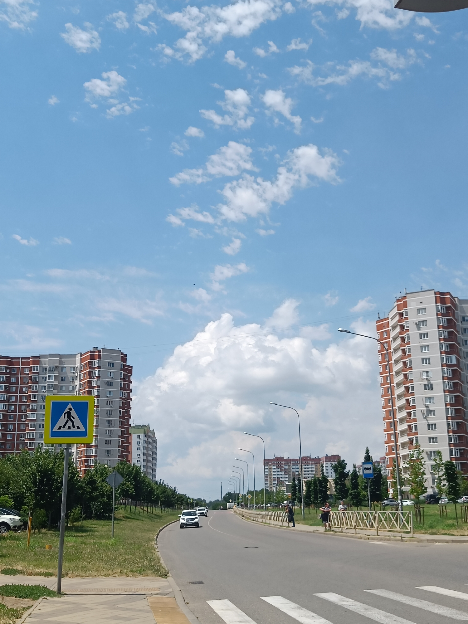 Red and white apartment block on a Krasnodar residential street