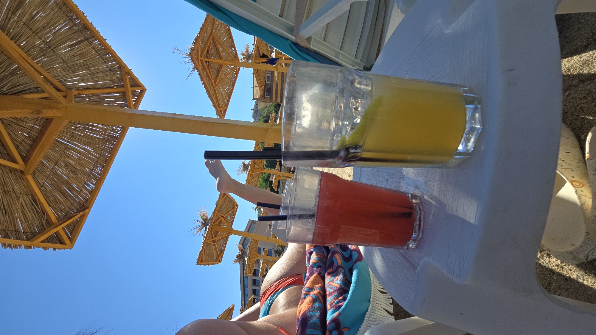 Drinks, selfies, and sunglasses reflections at a sunny beach