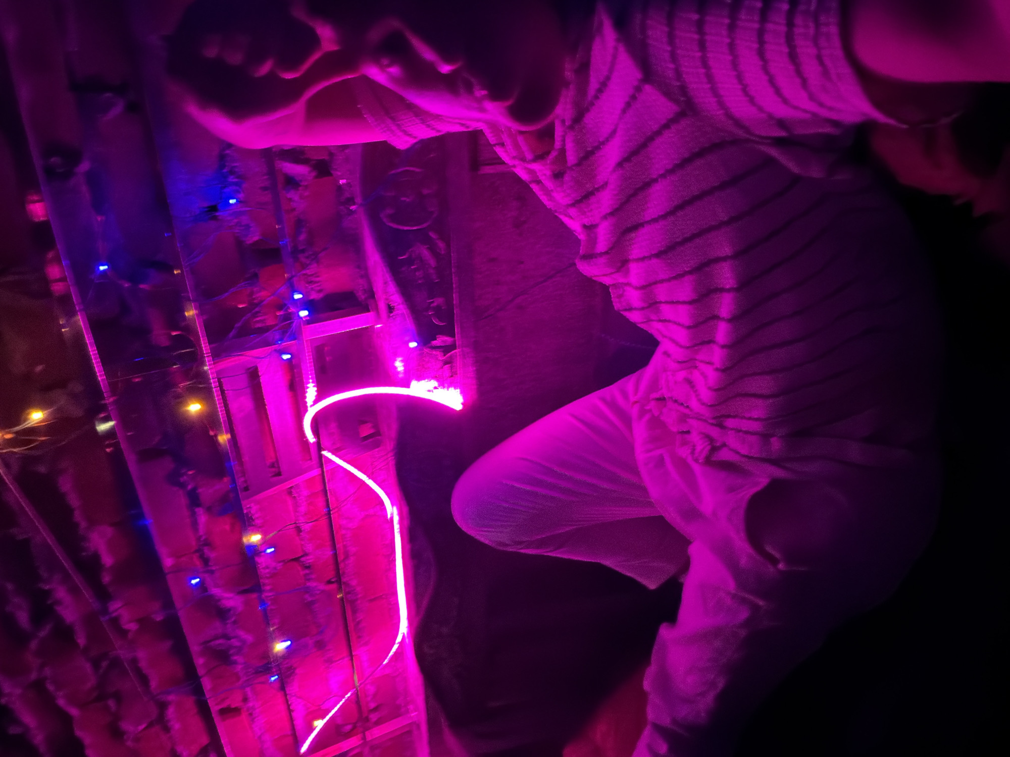 Neon-lit Delhi evening: rooftop vibes and a plane overhead